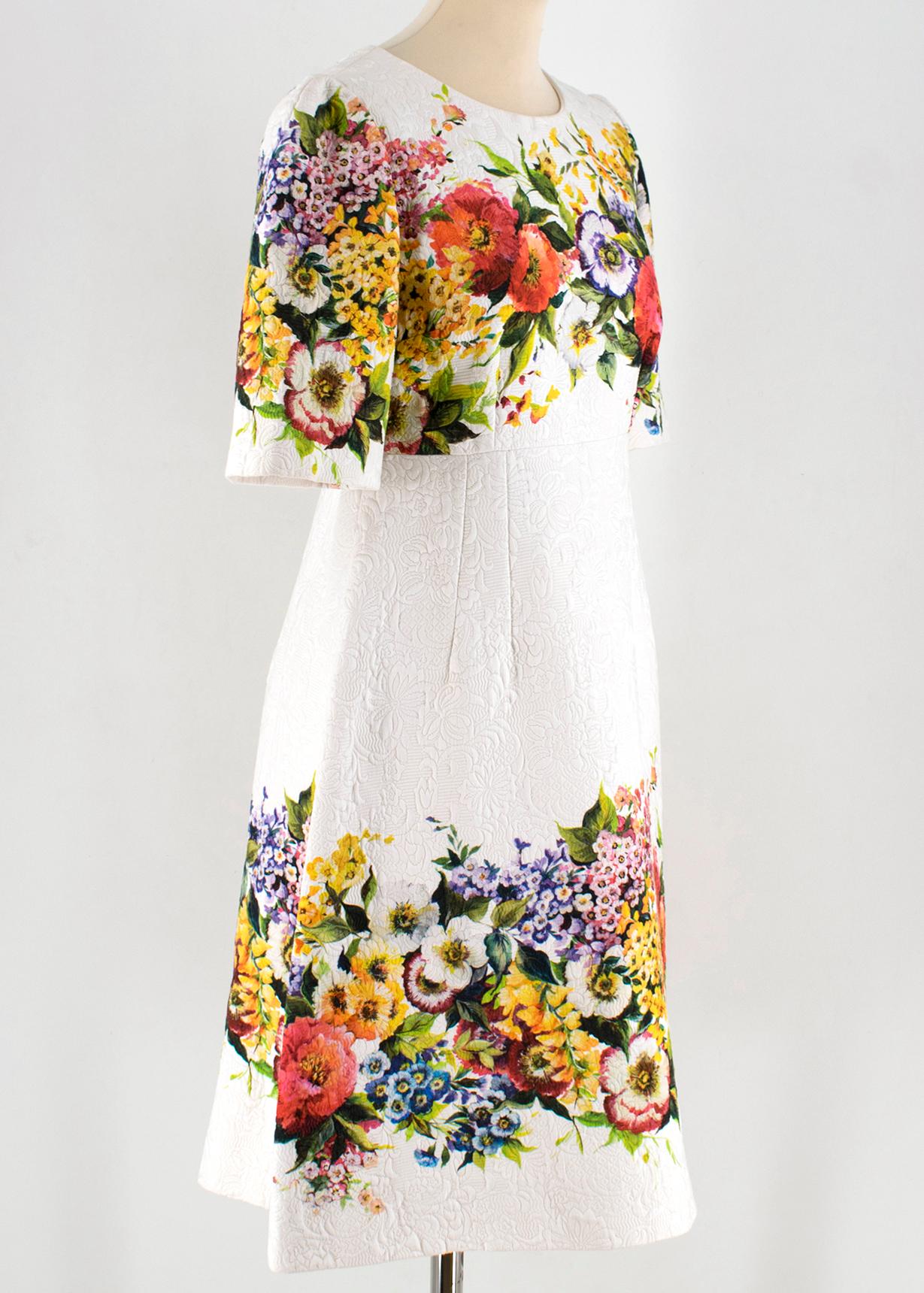 Dolce & Gabbana Jacquard Floral Print Dress

- beige cotton blend dress
- floral pattern embellishment  to the top and bottom 
- a- line silhouette  
- silk lining 
- zip fastening to the back 
- medium length

Please note, these items are pre-owned
