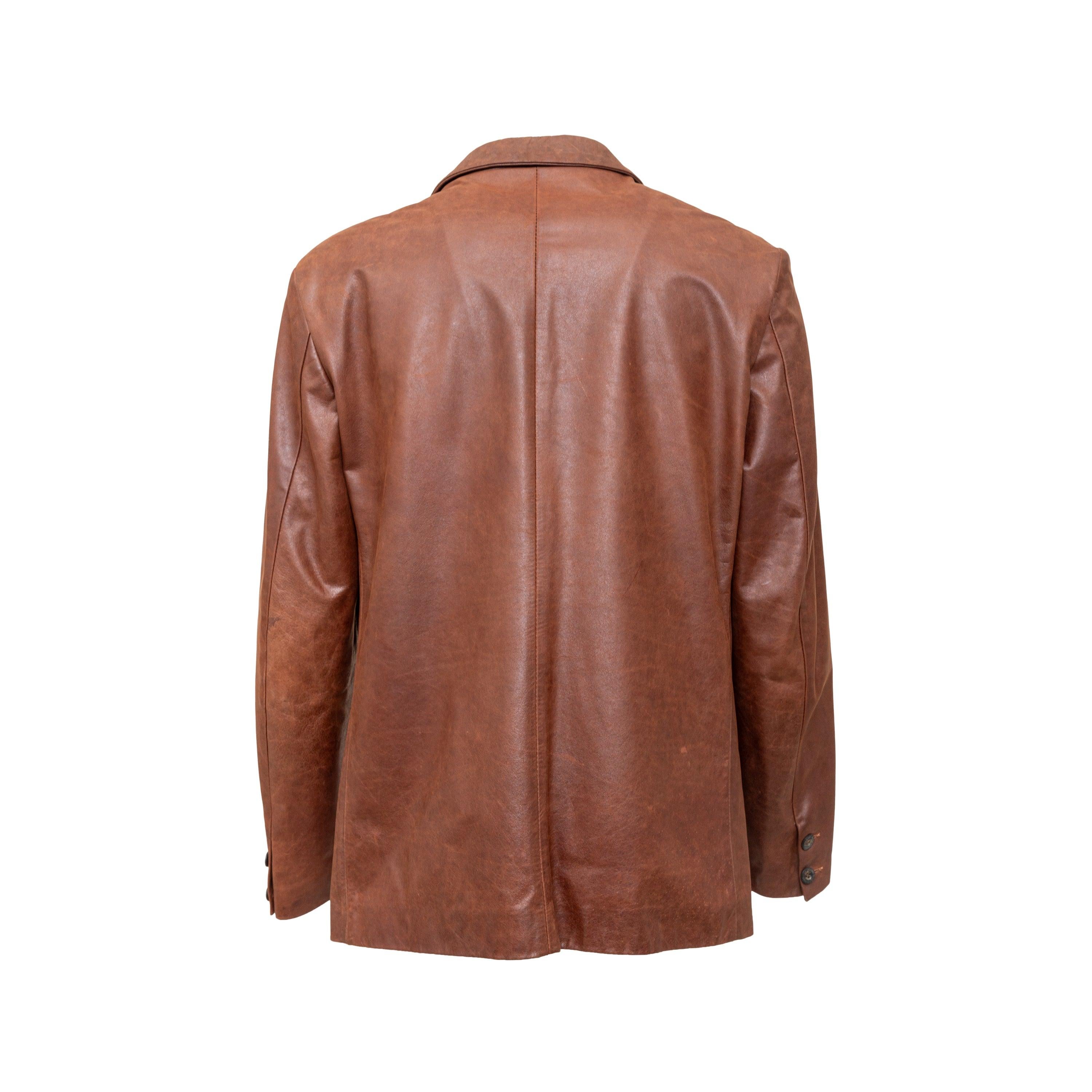 From the J&ans label by Dolce & Gabbana, this leather jacket features a blazer fit in a classic brown color. It includes a notched lapel collar with a 3 button front closure, one chest pocket, and a mesh lined interior for added comfort. 
 Remarks: