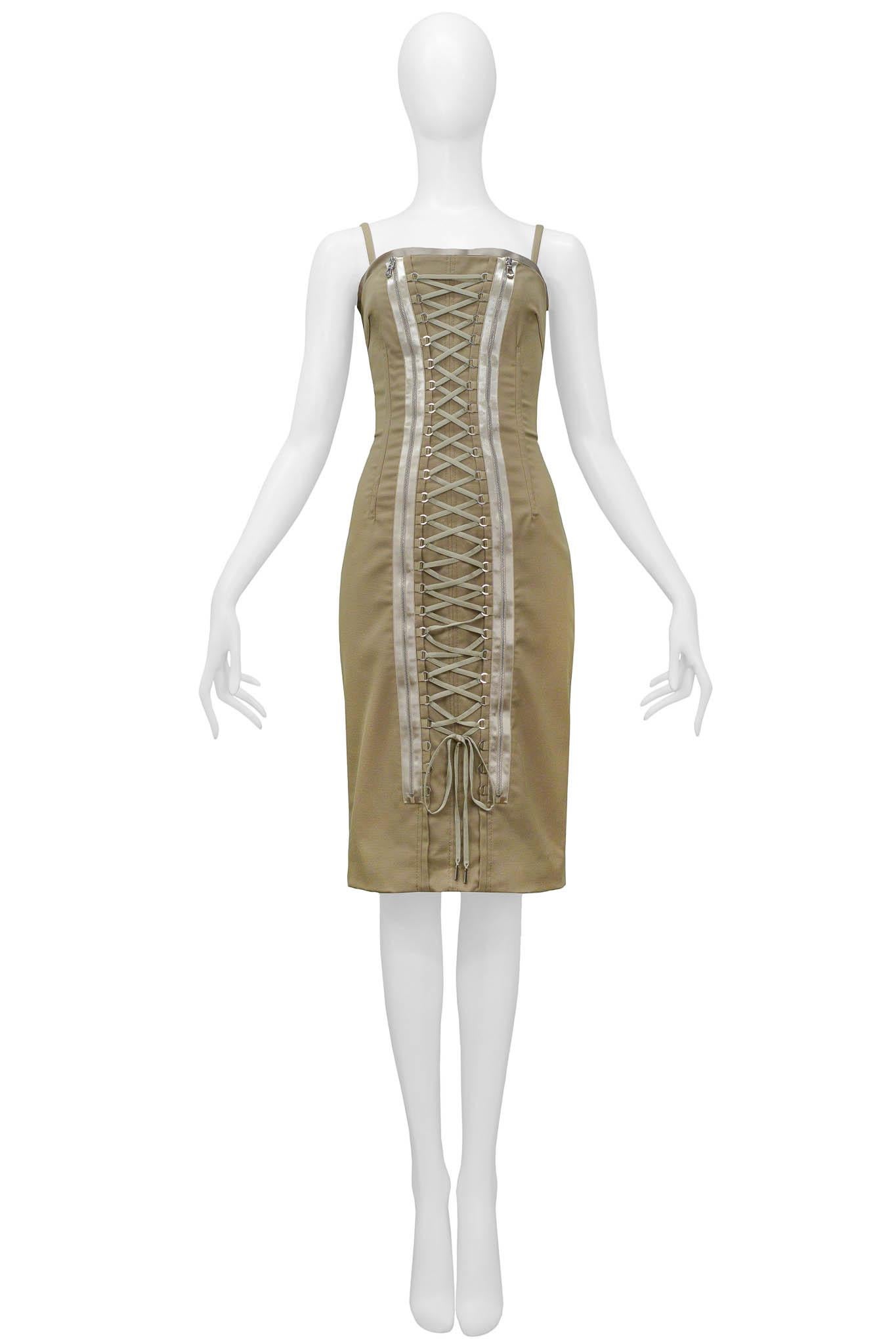 Resurrection Vintage is excited to offer a vintage Dolce & Gabbana khaki corset dress featuring, lace-up detailing and zippers down the front of the dress, satin trim along the top of the dress, and a kick pleat in the back.

Dolce & Gabbana
Size