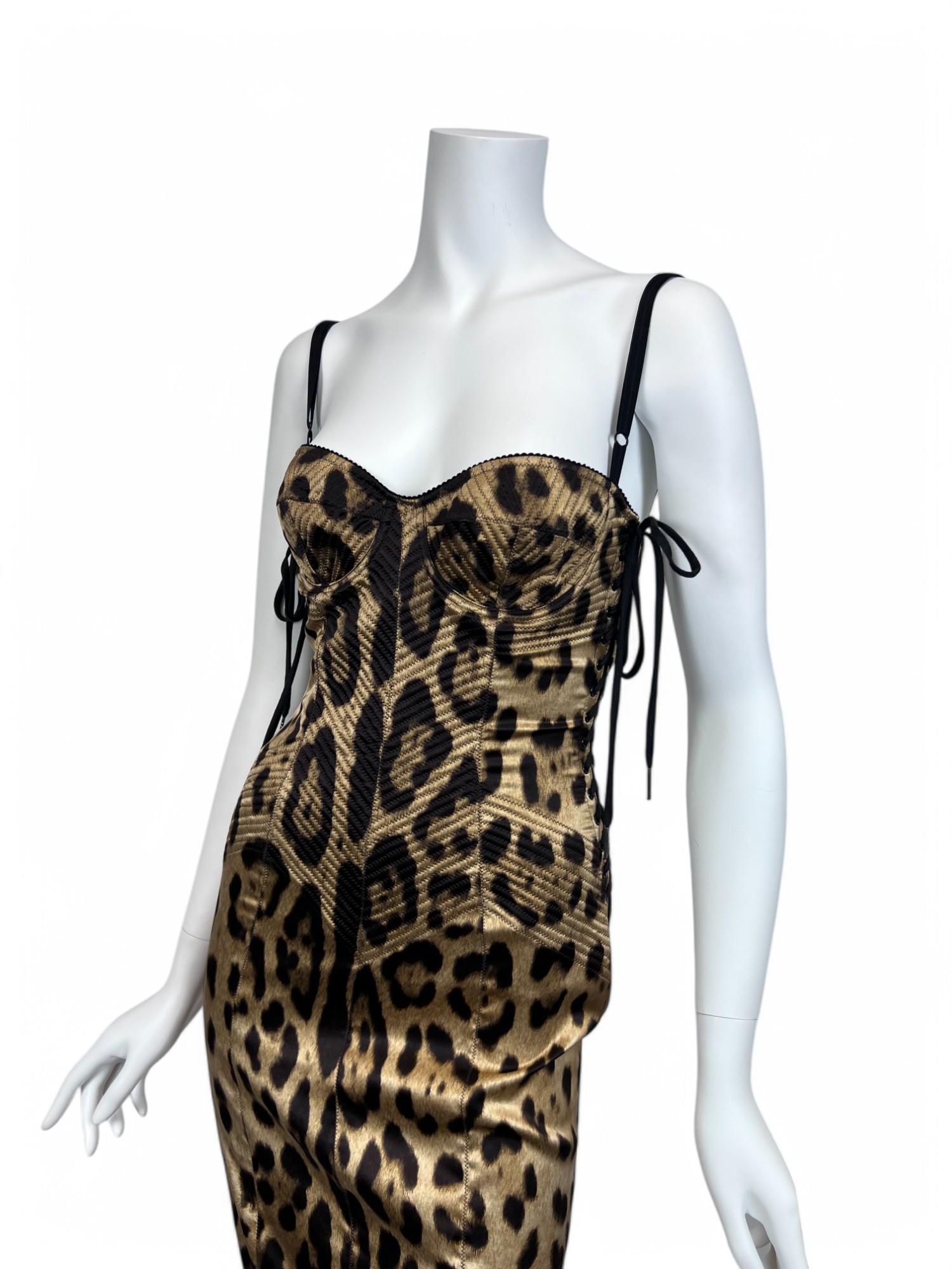 Exuding timeless elegance with a seductive edge, this Dolce & Gabbana Lace-Up Silk Corset Dress is a masterpiece of the brand’s signature craftsmanship. Crafted from luxurious silk, the dress features a meticulously structured corset bodice that