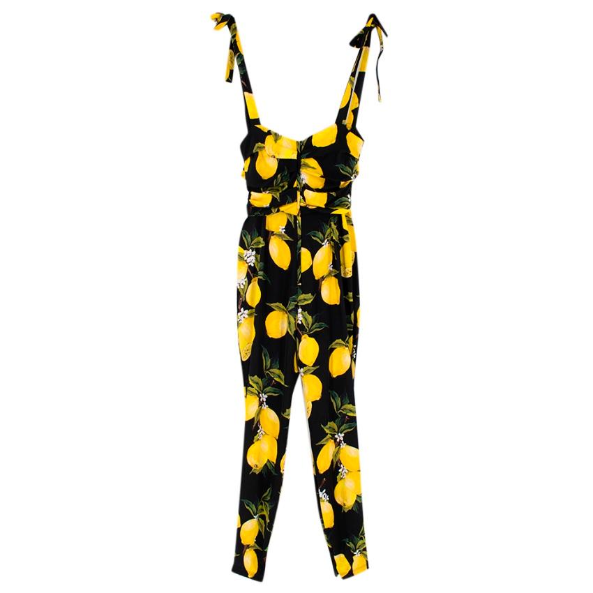 Dolce & Gabbana Lemon-Print Charmeuse Jumpsuit 

This eye-catching lemon-print jumpsuit is crafted from black and yellow stretch silk, and features a square neck, shoulder straps, pleated details, a concealed rear zip fastening, a slim fit and a