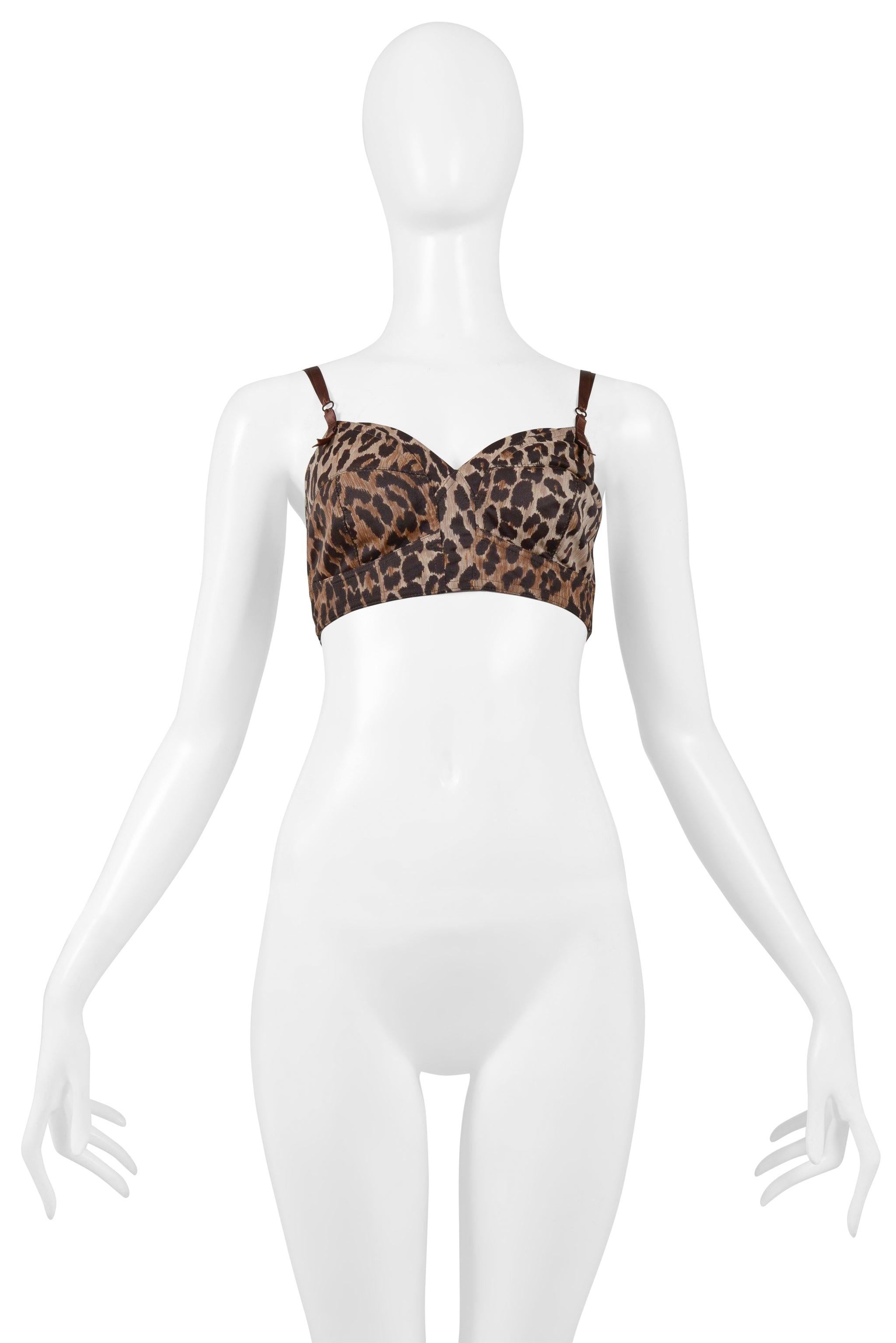 Resurrection Vintage is delighted to offer a vintage Dolce & Gabbana leopard bustier bra top from the 1997 collection. The top features intricate stitch outlining, off-white interior mesh lining, brown ribbon adjustable straps with bow detailing at