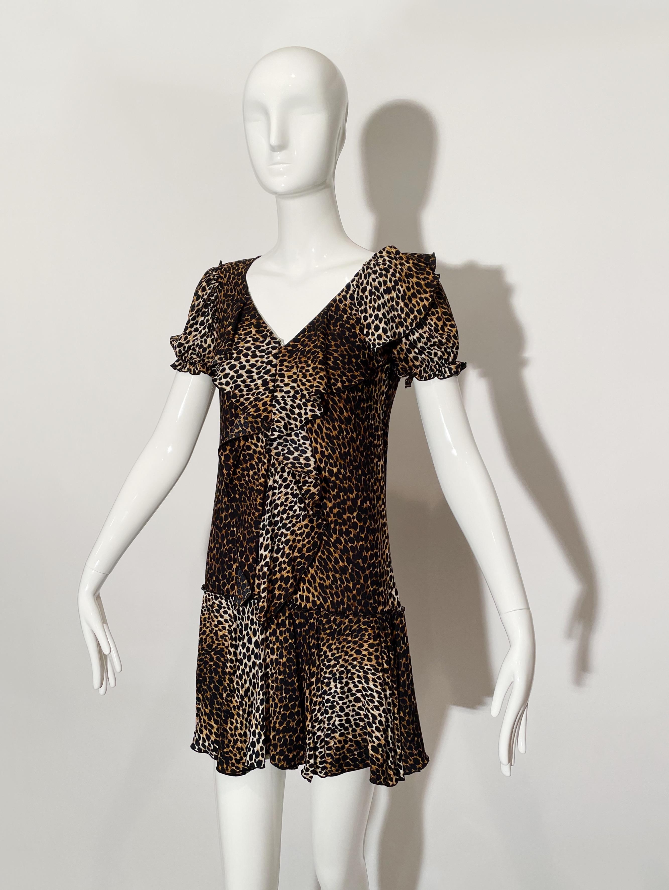 Leopard print mini dress. Puffed Sleeves. Front ruffle detail. Drop waist. Back zipper closure. Viscose. Made in Italy.

*Condition: excellent vintage condition. No visible flaws.


Measurements Taken Laying Flat (inches)—

Shoulder to Shoulder: 15