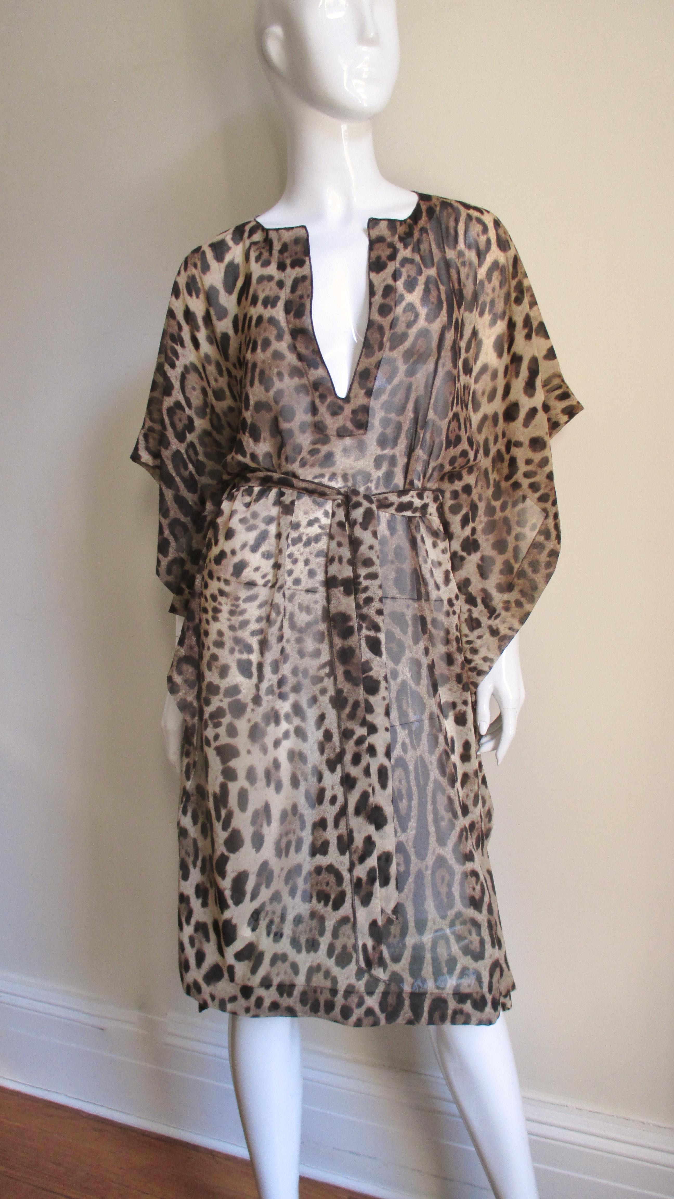 A fabulous silk leopard print caftan dress from Dolce & Gabbana.  It has a V neckline, drop shoulders,  and comes with a matching tie belt.  The dress is unlined and slips on over the head.
Fits sizes Small, Medium, Large.

Bust to 44