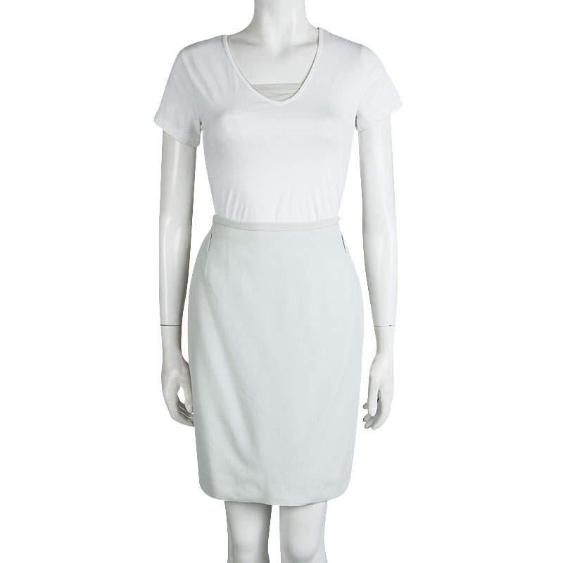Dolce & Gabbana demonstrates minimalistic proportions in this skirt. Made in Italy in light grey hue to match with countless tops, this skirt is constructed in a form-flattering pencil silhouette. It is fashioned with belt loops along the waist and