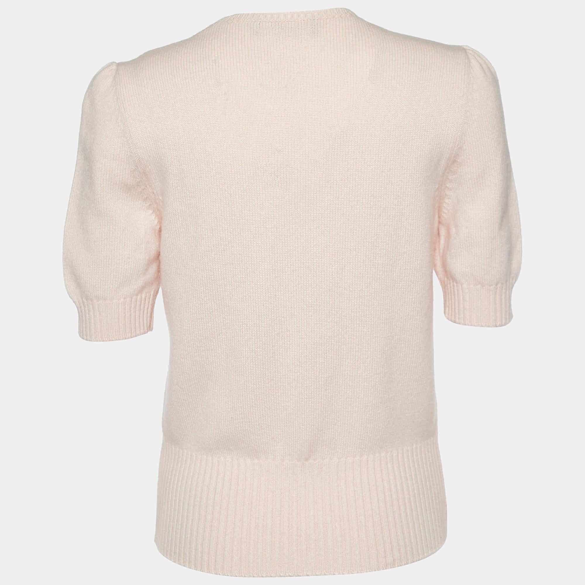 Indulge in the luxurious embrace of the Dolce & Gabbana sweater. Crafted with unparalleled precision, this garment exudes elegance and warmth. Its delicate hue whispers sophistication, while the endearing 