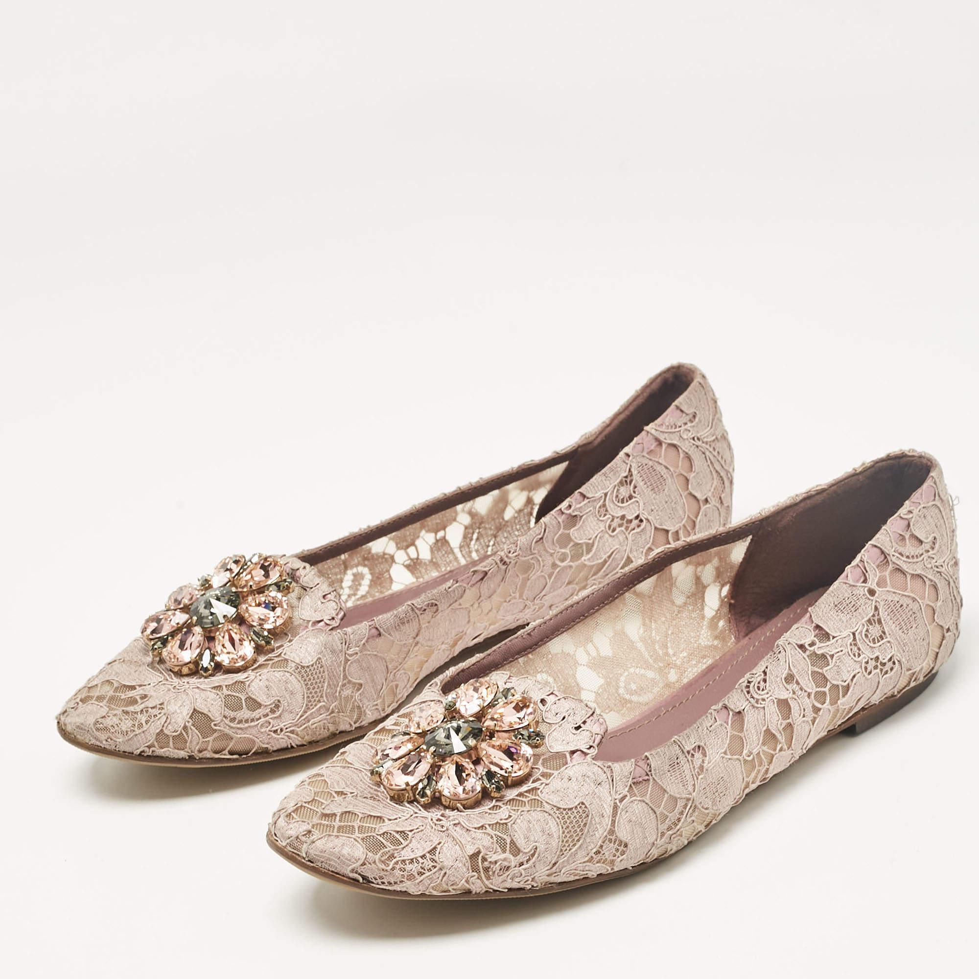 Add a touch of opulence to your footwear collection with these Dolce and Gabbana smoking slippers. Exquisitely crafted the slippers feature a lace construction adorned with shimmering crystals that elevate their elegance. The soft light purple hue