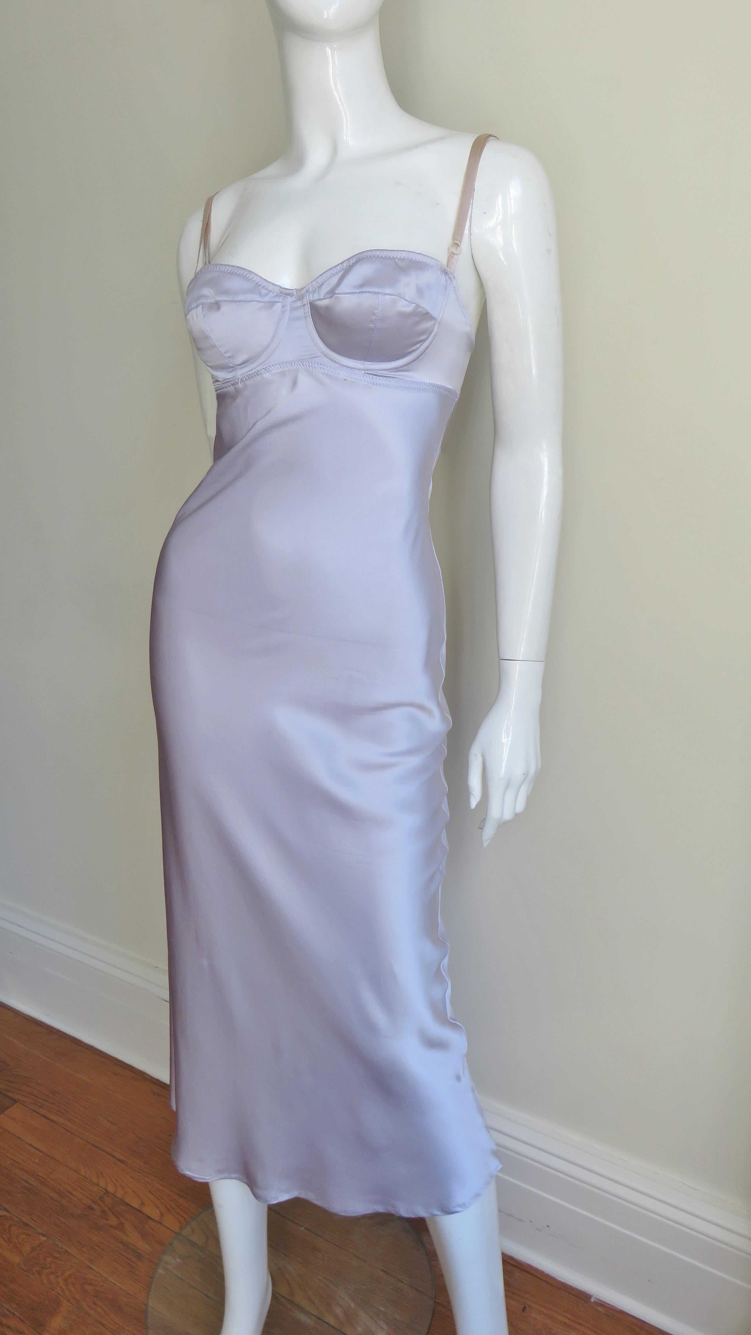 A gorgeous lilac silk dress from Dolce & Gabbana.  It is lingerie inspired with a boned bra style top and adjustable nude straps. The dress skims the body subtly flaring towards the hem.  It has a hook and eye closure at the top back of the dress