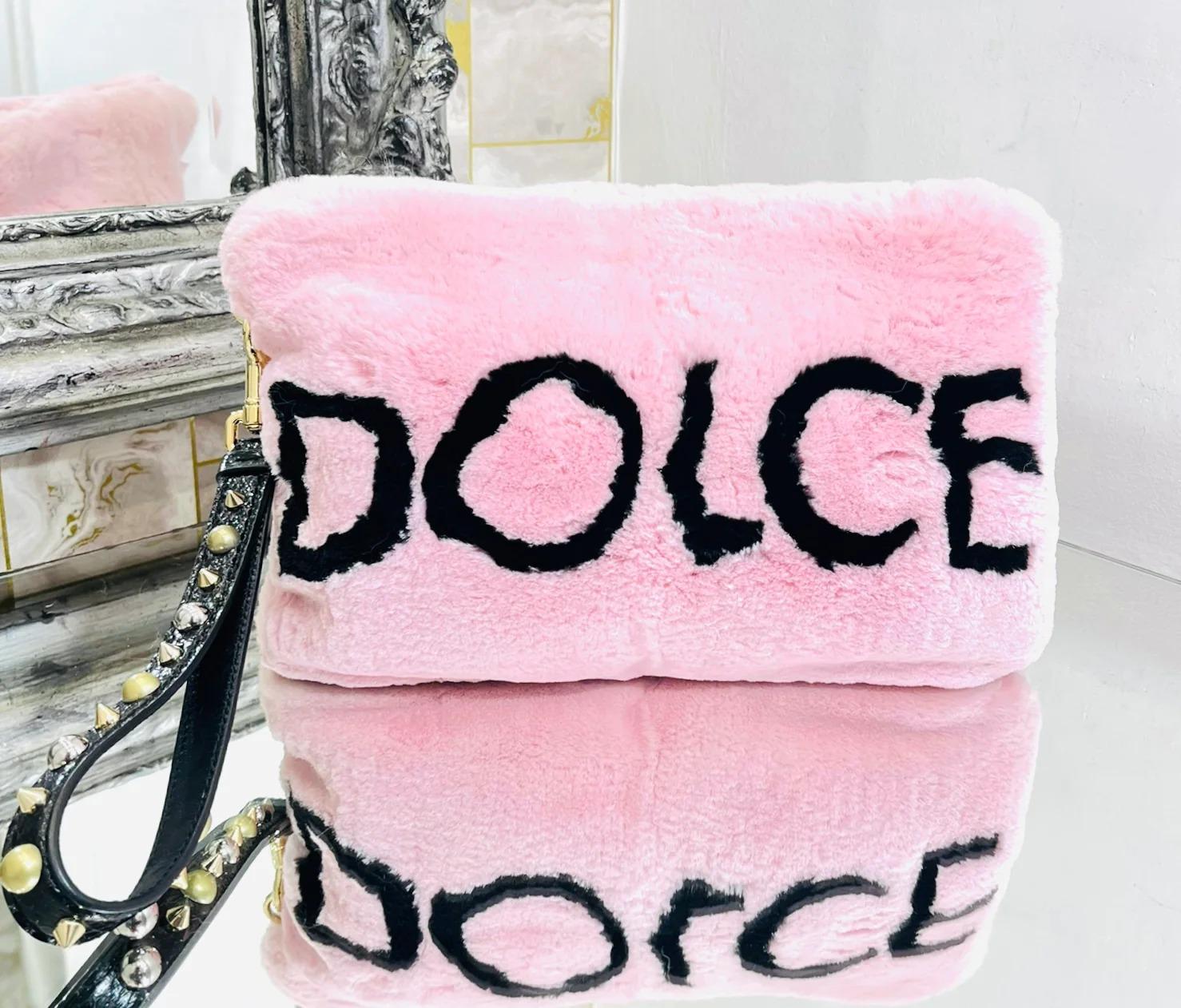 Dolce & Gabbana Logo Wristlet Rabbit Fur Clutch Bag

Cleo, baby pink wristlet clutch with black ‘Dolce & Gabbana’ logo lettering to the front and rear. Wristlet in black leather tag embellished with gold and silver studs. Top zip fastening and