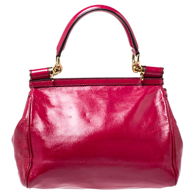 This gorgeous pink Miss Sicily satchel from Dolce & Gabbana is a handbag coveted by women around the world. It has a well-structured design and a full flap that opens to a compartment with suede lining and enough space to fit your essentials. The