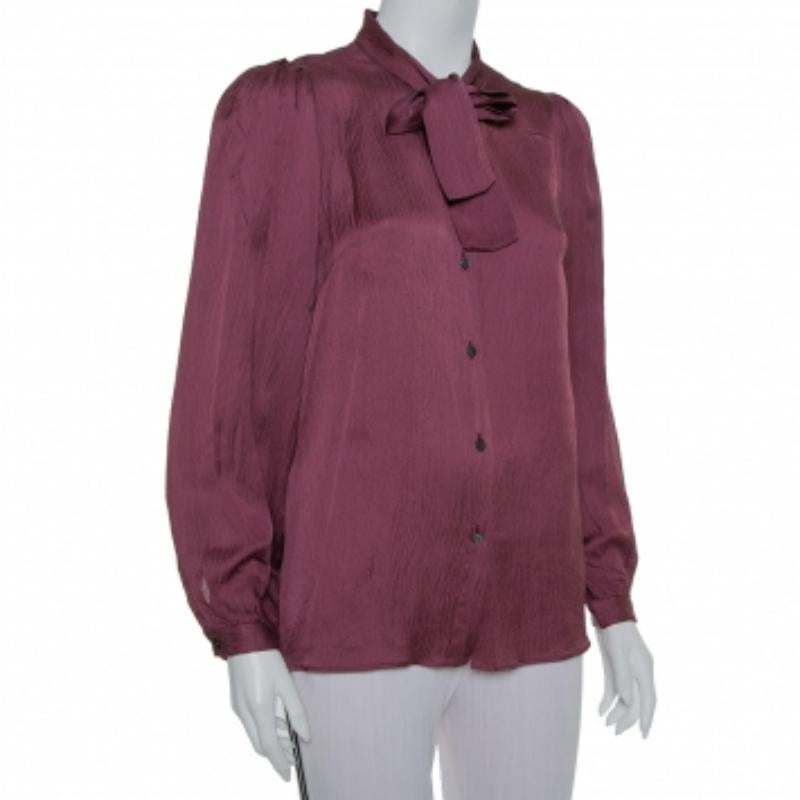 Exhibiting a sophisticated design, this mahogany red Dolce & Gabbana top is a wardrobe staple. It is made of 100% crushed silk and features trendy neck tie detailing, front button fastenings, and long sleeves. It will look great on you and can be