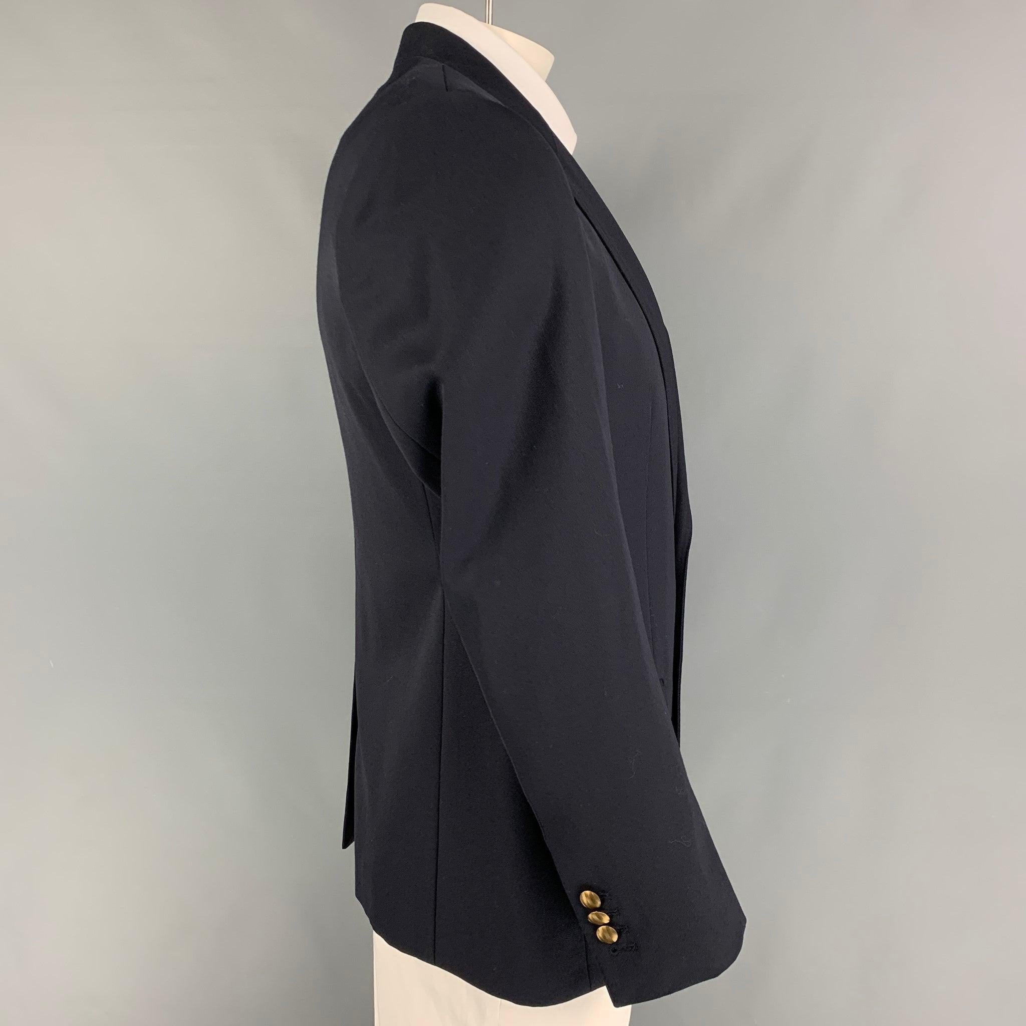 DOLCE & GABBANA 'Martini' sport coat comes in a navy wool / silk with a full liner featuring a peak lapel, flap pockets, single back vent, and a double button closure. Made in Italy.
Excellent
Pre-Owned Condition. 

Marked:   52 

Measurements: 
