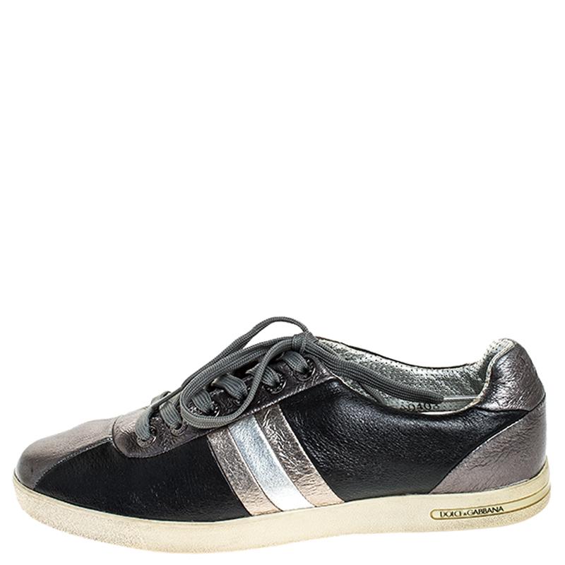 Trust Dolce & Gabbana to make you stand out with these sneakers! They've been crafted from leather and styled with a striped pattern on the sides and a combination of metallic grey and black hues. They feature round toes, lace-ups on the vamps and