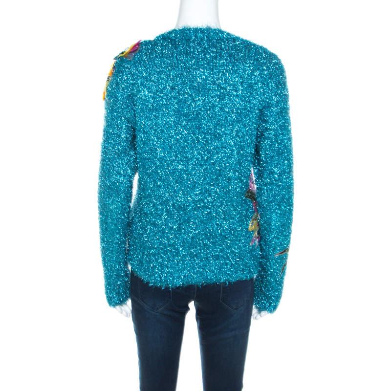 Dolce and Gabbana combines a feminine aesthetics and refined fashion in this glamorous sweater. The beguiling metallic blue hue and floral appliques accentuate the relaxed silhouette and make it apt for an evening outing. It is designed with a crew