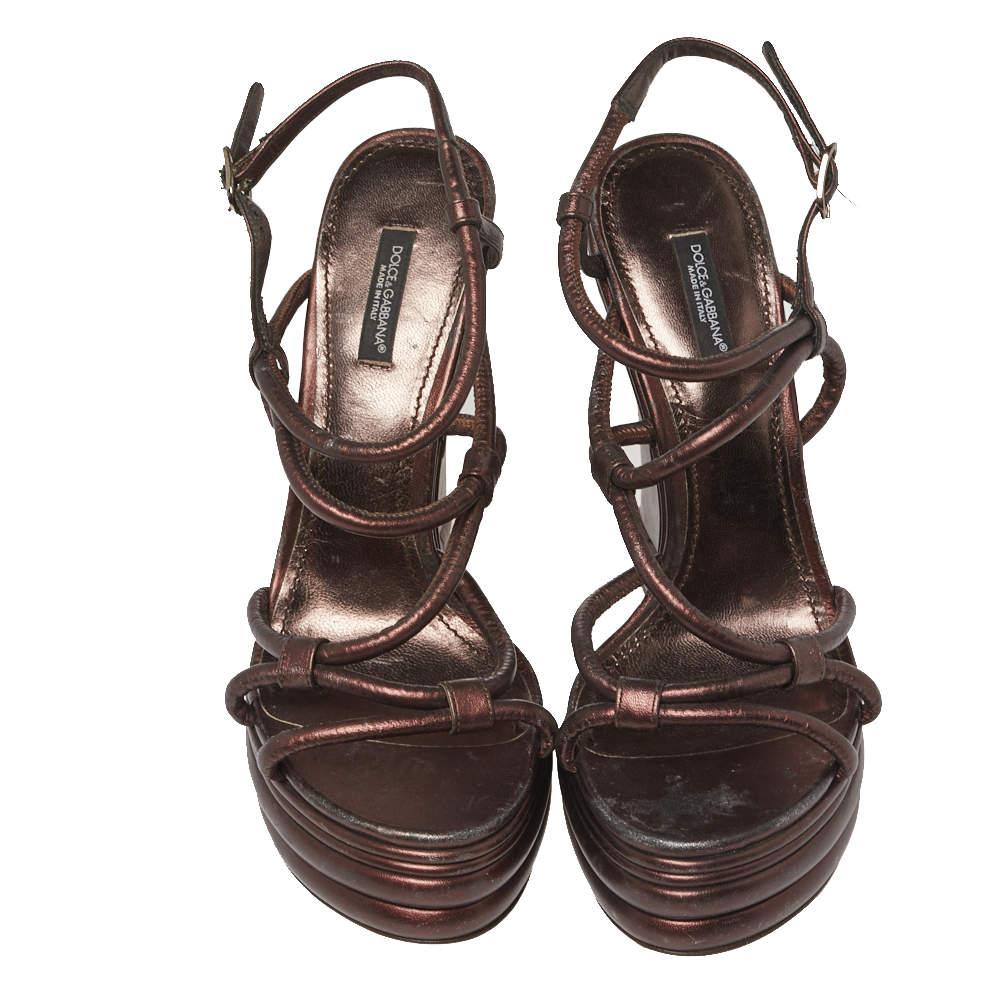 Dolce and Gabbana sandals are known for their intricate detailing and fine Italian finish. These sandals from this celebrated house of fashion are crafted with leather in metallic brown hue. Elevated at 15.5 cm wedge heel, this one is well adorned