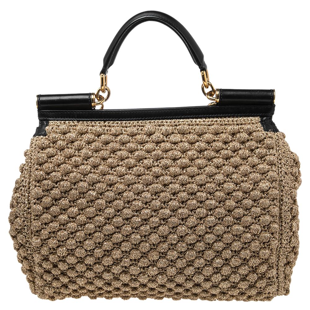 The iconic Miss Sicily bag by Dolce & Gabbana exhibits the aesthetic of Italian glamour. The neat silhouette is made from leather & crochet and features a front flap accented with the signature logo plaque. The creation is complemented with