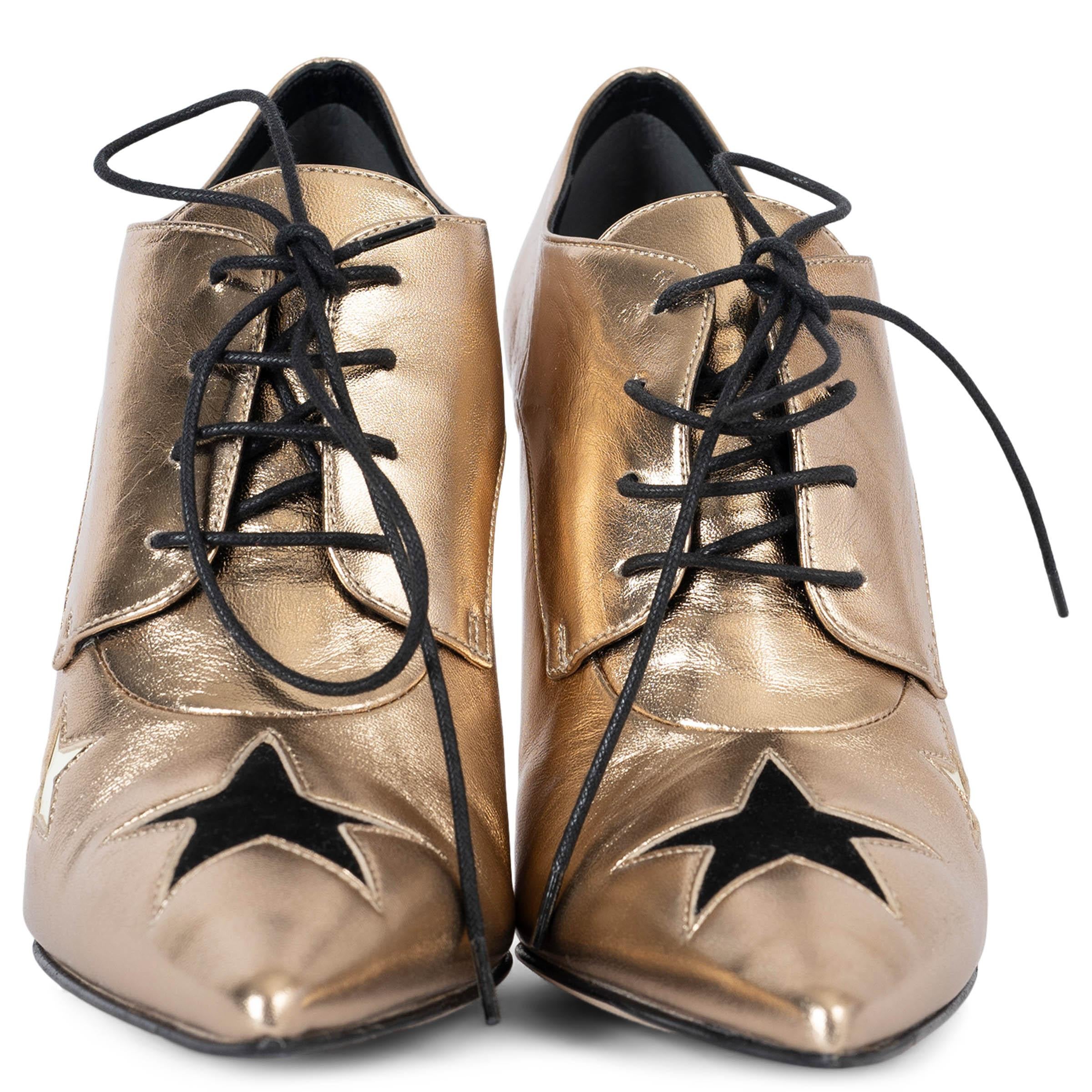 100% authentic Dolce & Gabbana pointed-toe lace-up metallic gold leather booties embellished with black and ivory stars. Have never been worn but show a few faint scratches tot the heel. Overall in excellent condition. 

2011