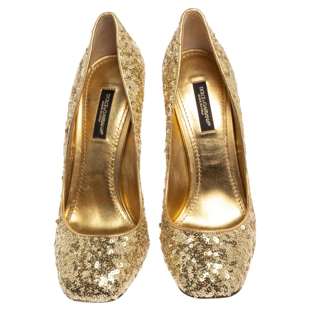 Be ready to catch the light whenever you step out in this pair of pumps by Dolce&Gabbana. They are covered in metallic gold sequins and balanced on 11cm high block heels, accented with crystal stud embellishments. You can glitter away at evening