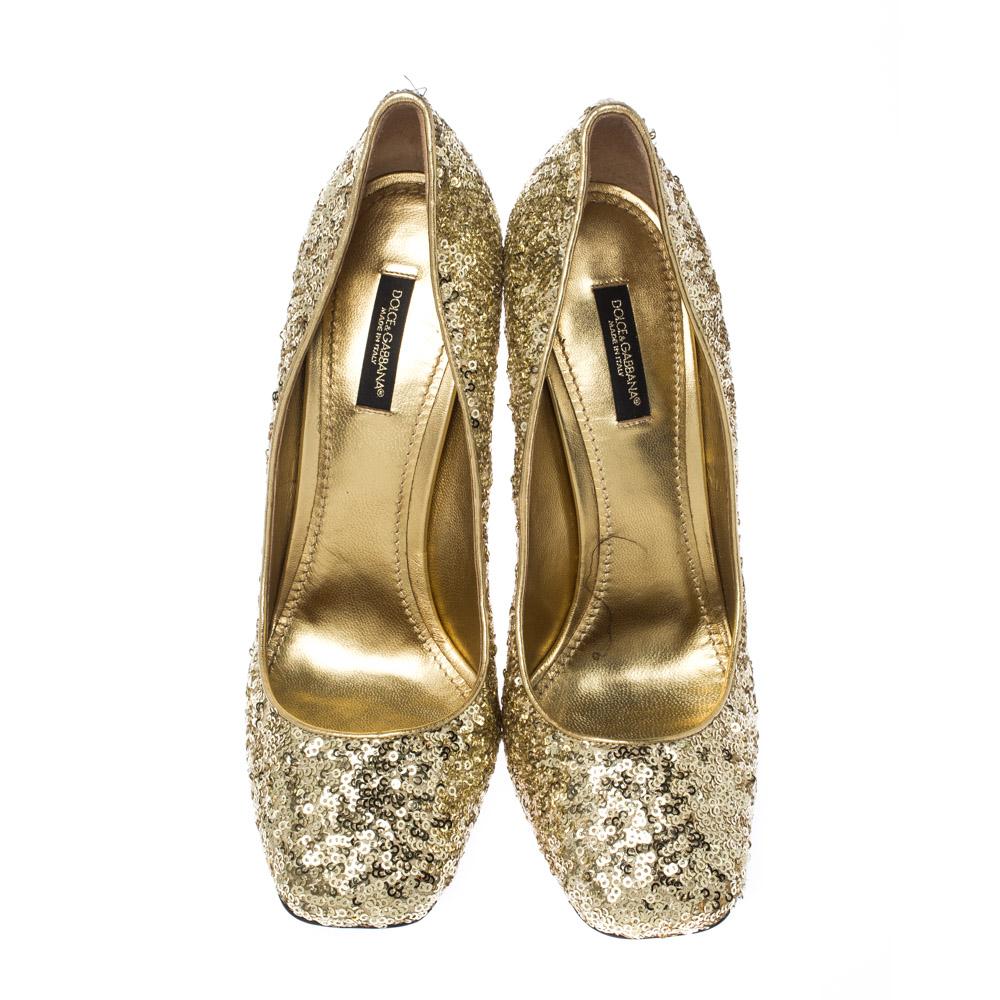 Be ready to catch the light whenever you step out in this pair of pumps by Dolce&Gabbana. They are covered in metallic gold sequins and balanced on 11cm high block heels, accented with crystal stud embellishments. You can glitter away at evening