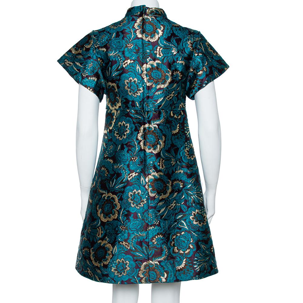 Dolce & Gabbana's mini dress reflects traditional Chinese cheongsam dresses. It's cut from plush jacquard woven with metallic green flowers and has sharp, structured sleeves. Match a pair of earrings to the sparkling row of embossed coins, crystal,