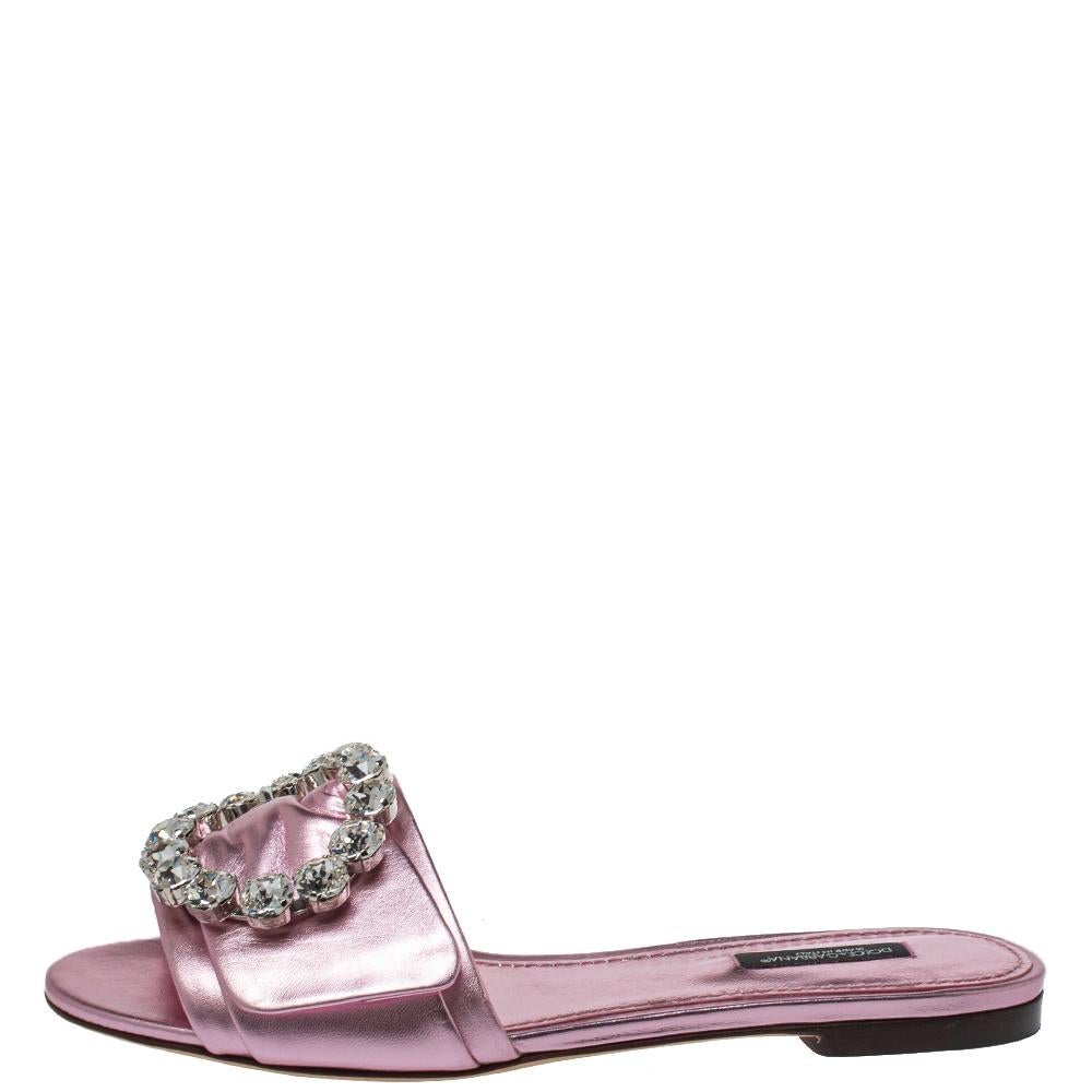 These chic flats by Dolce & Gabbana are for days of ease and style. The dainty pink flats will look elegant with any ensemble. Crafted from metallic pink leather, they have dainty crystal embellishments on the uppers, open toes, and leather soles.

