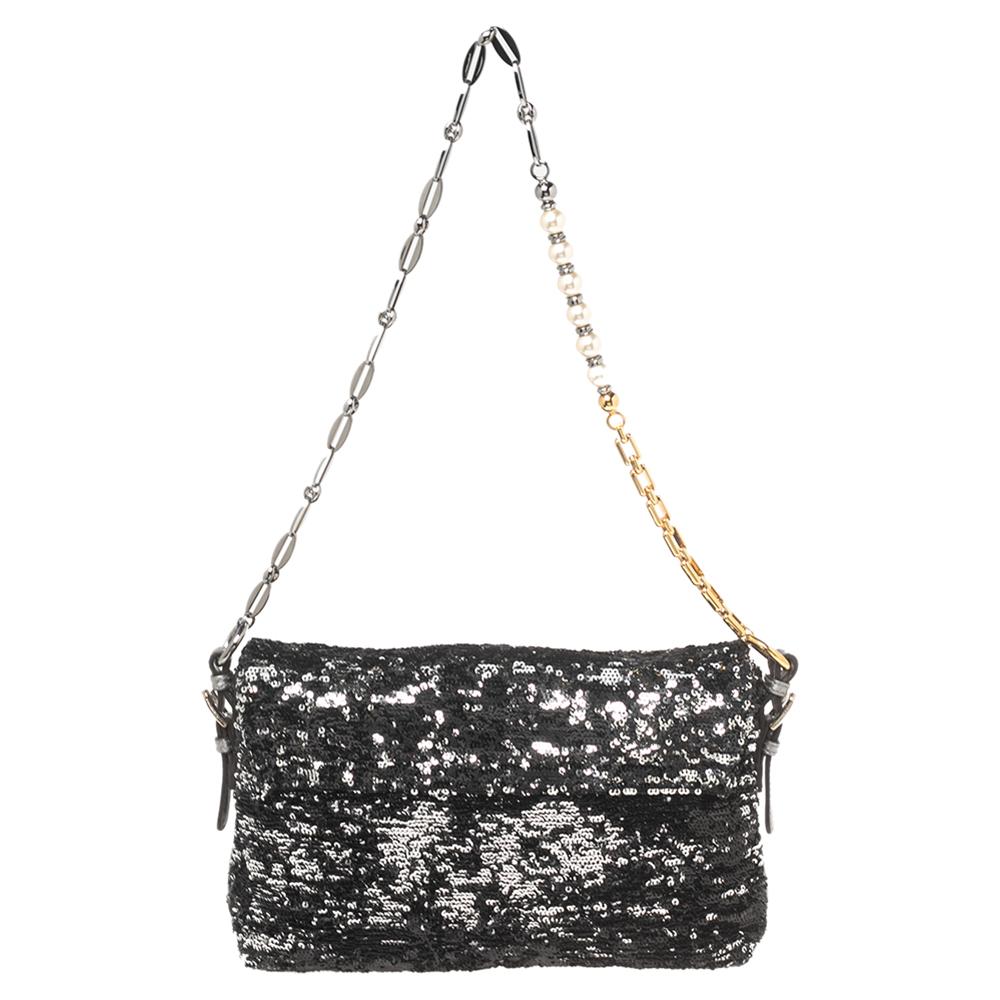 Gorgeous and glamorous, this Miss Charles bag from Dolce & Gabbana is simply a must-have for your party wardrobe upgrade. It is created using metallic sequins leather, with a gold-toned plaque adorning the front. It has a satin-lined interior and a