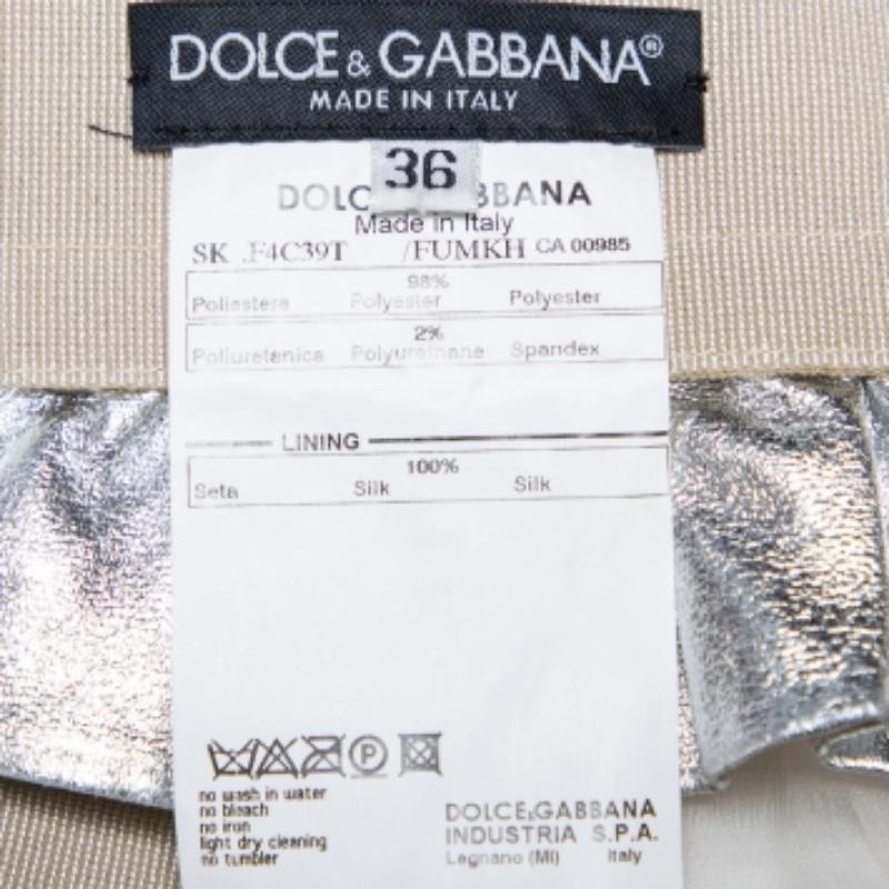 Trendy and stunning, this enchanting skirt from Dolce & Gabbana will elevate your look. It has a metallic silver faux leather body and an elastic waist. Pair with simple tops and heels.