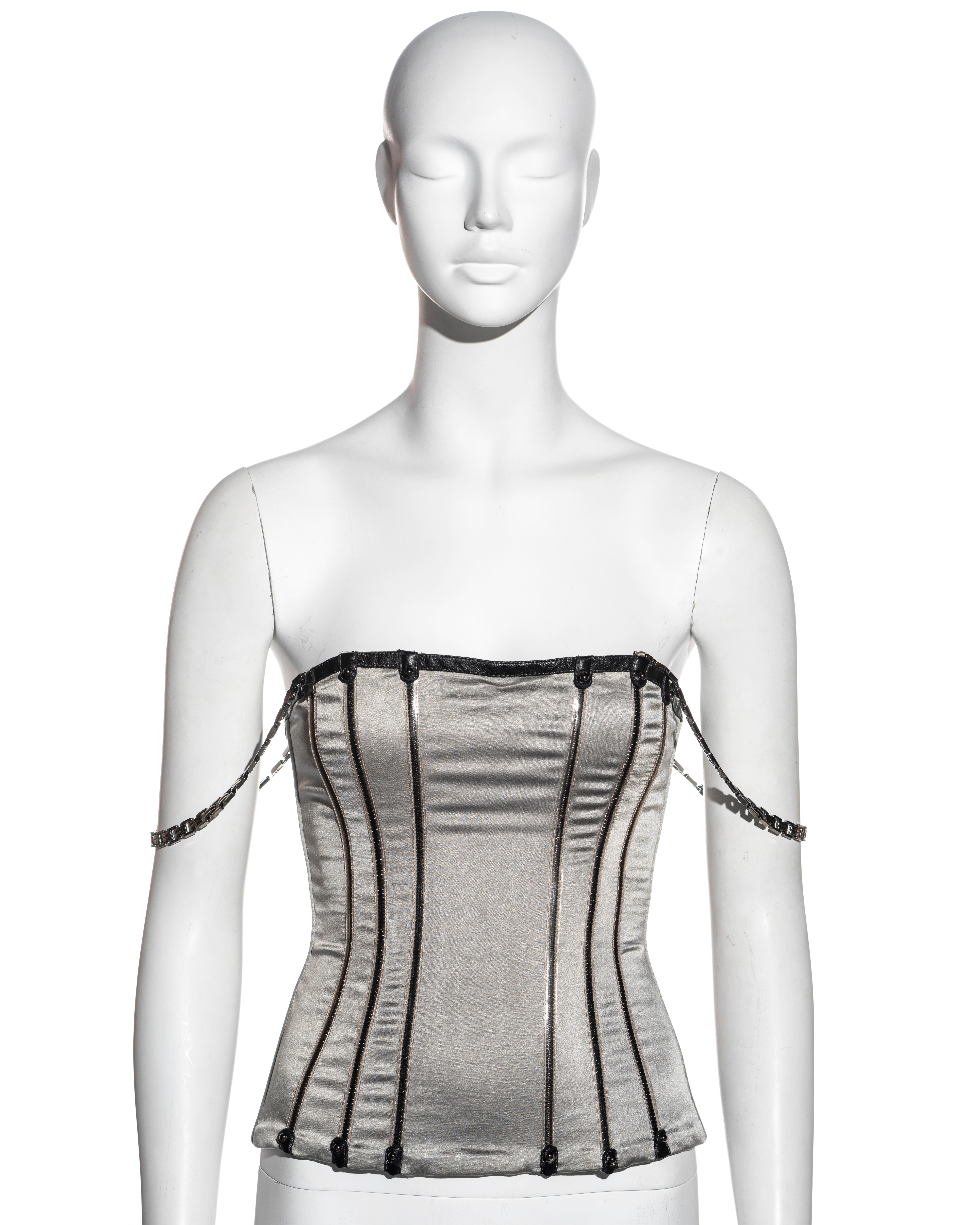 ▪ Dolce & Gabbana corset top
▪ Metallic silver silk elastane 
▪ Silver lambskin leather boning channels 
▪ Black lambskin leather trim 
▪ Silver metal link chain shoulder straps 
▪ Centre-back zipper 
▪ Size approx. IT 42 - FR 38 - UK 10
▪