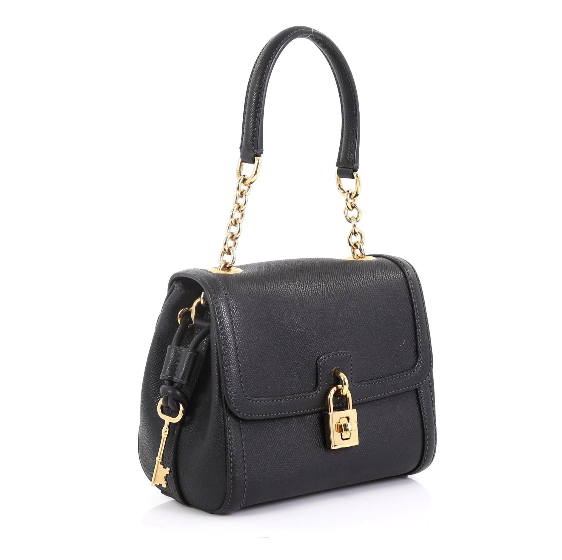 This Dolce & Gabbana Miss Bonita Satchel Leather Mini, crafted in black leather, features a chain-link and leather handle, frontal flap, and gold-tone hardware. Its decorative lock with twist-lock closure opens to a cheetah print fabric interior