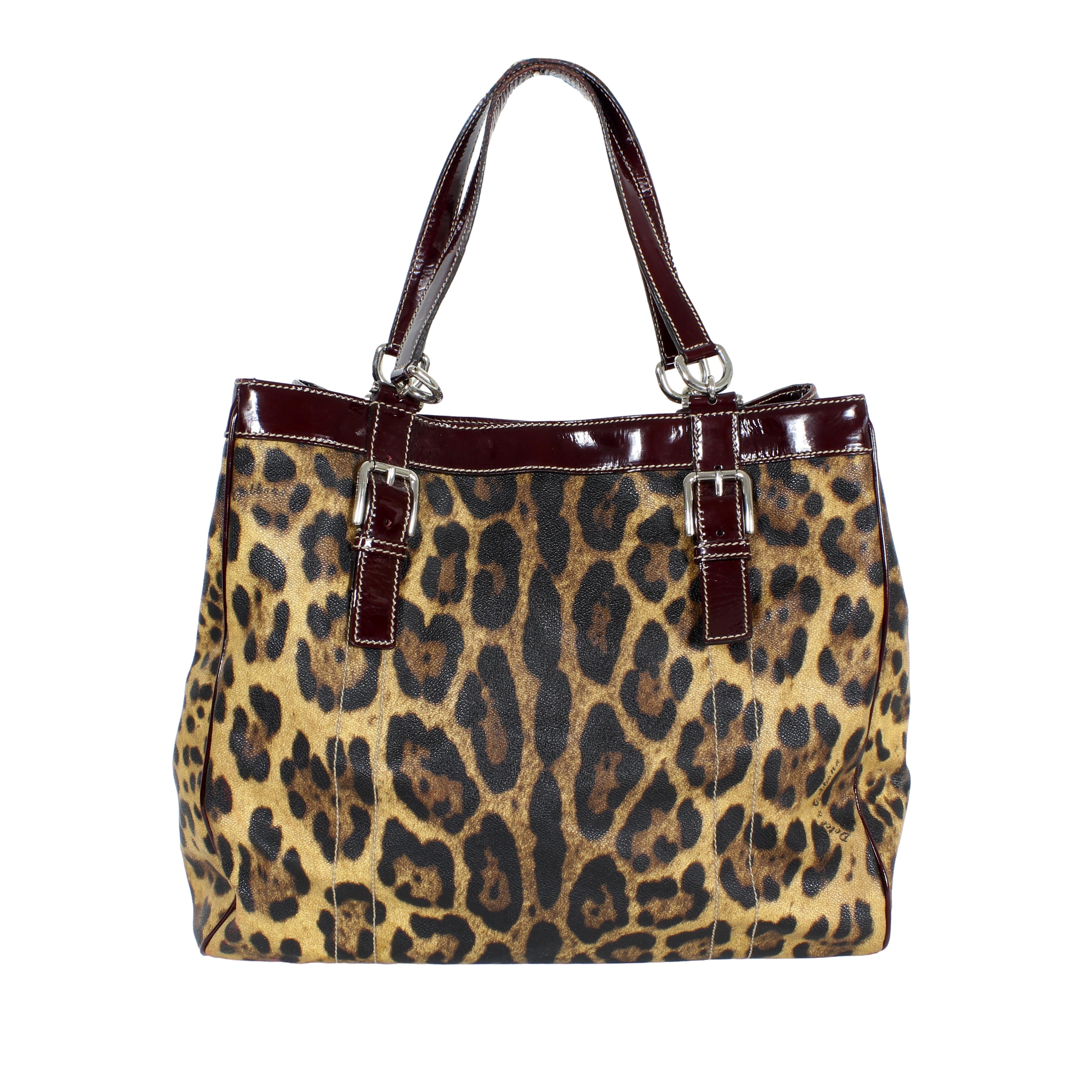 This striking Dolce & Gabbana Miss Easy Way shopper bag from the early 2000s is a prime example of the brand's bold and glamorous aesthetic. Crafted from fabric with an eye-catching leopard print in classic brown and black tones, this bag exudes