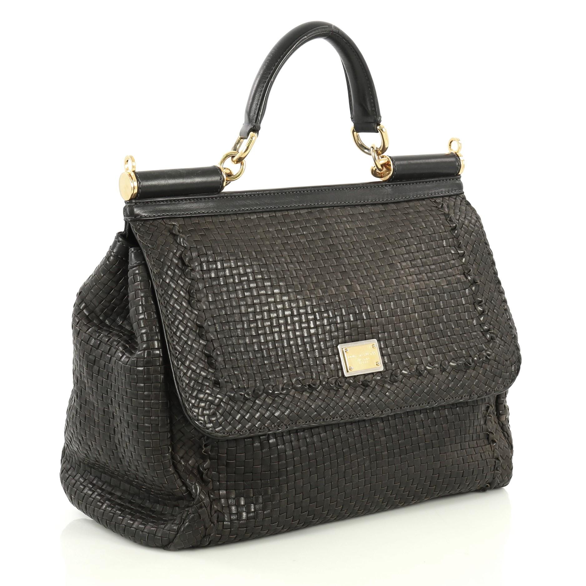 This Dolce & Gabbana Miss Sicily Bag Woven Leather Large, crafted in black leather, features a leather top handle and gold-tone hardware. Its framed top flap with magnetic snap closure opens to a black and brown printed fabric interior with zip and