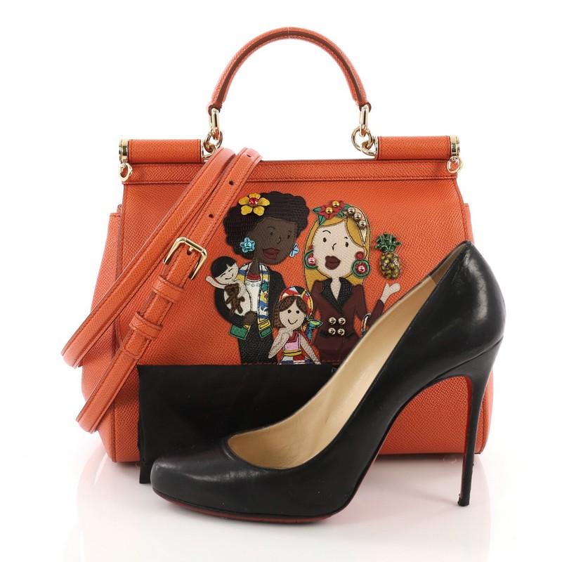 This Dolce & Gabbana Miss Sicily Family Handbag Patchwork Leather Medium, crafted from orange patchwork leather, features leather top handle, designer plaque, and gold-tone hardware. Its framed top flap with magnetic snap closure opens to a cheetah
