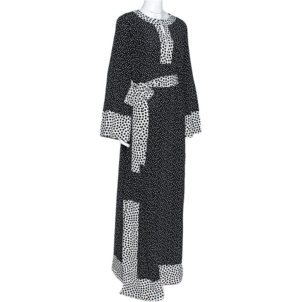 This stunning maxi dress comes from the iconic house of Dolce & Gabbana. It is crafted from pure silk and flaunts a polka-dotted print in a monochrome color scheme. It is great for a day out with friends and adds a touch of playfulness to your