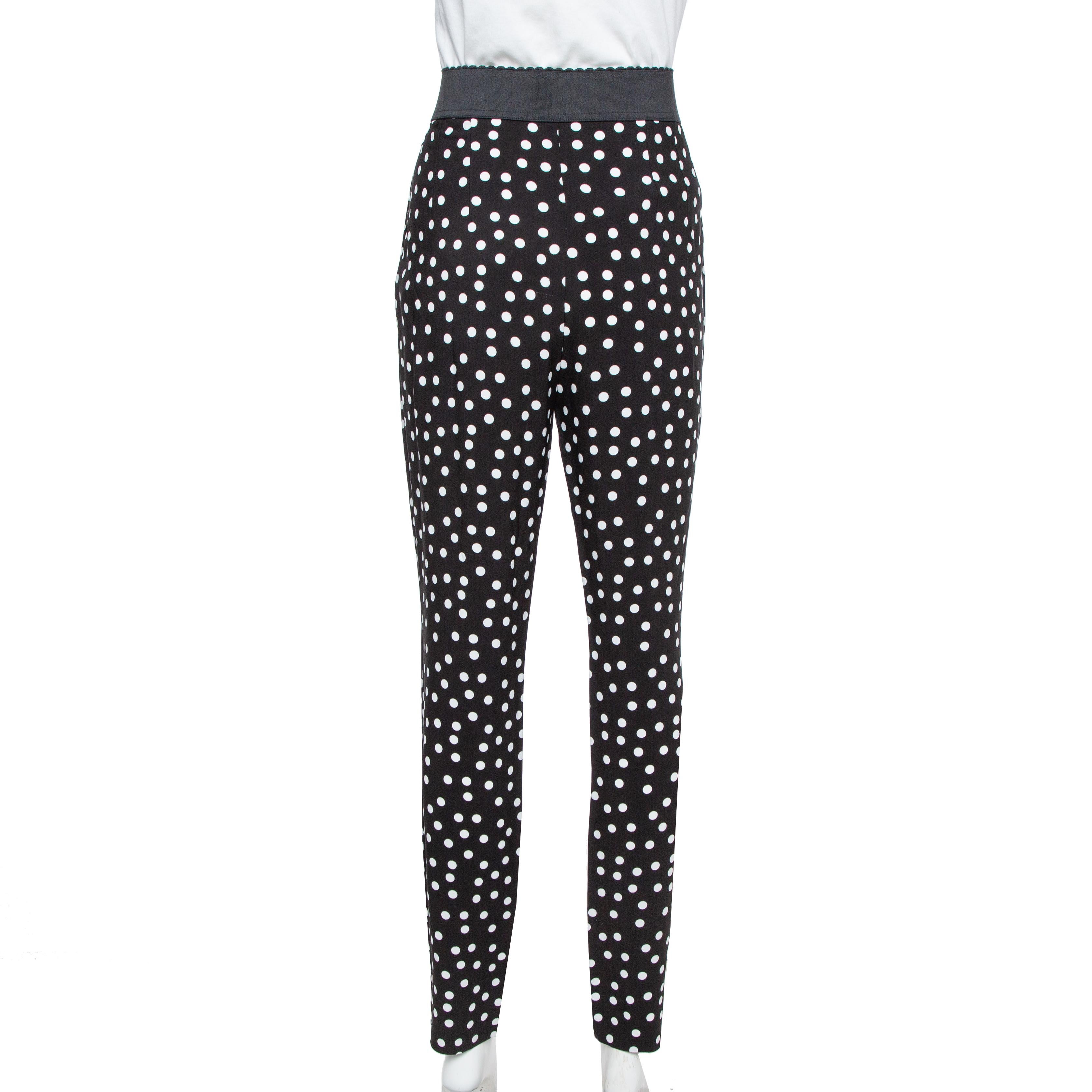These Dolce & Gabbana's trousers are cut from crepe in a black hue and decorated with white polka-dots. They are designed with an elasticated band that sits high on your waist and fits slim through the leg. Wear them with the coordinating blouse for