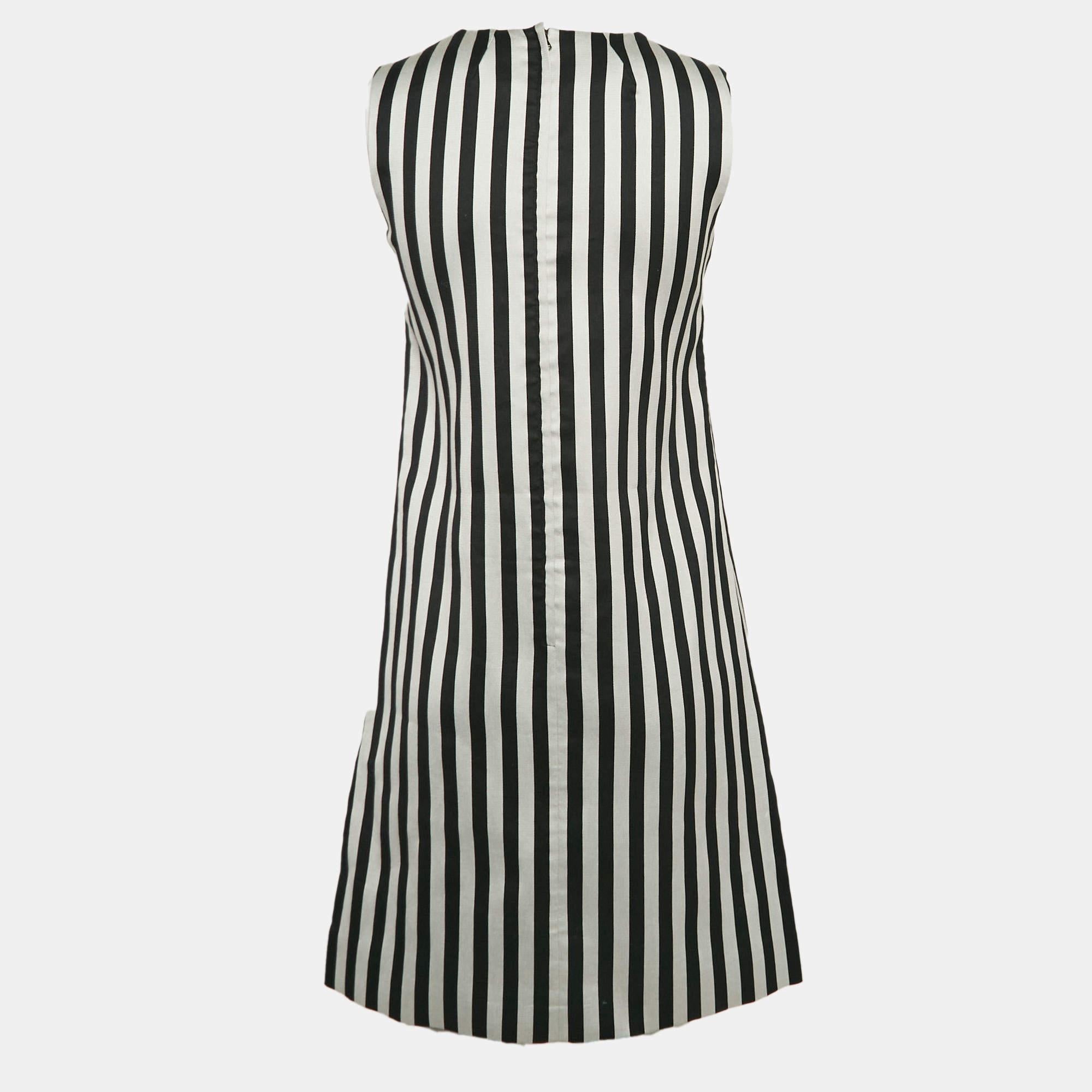 Masterful tailoring and timeless appeal characterize this dress from the house of Dolce and Gabbana. Presented in monochrome stripes it is nothing but pure charm and is a must have.