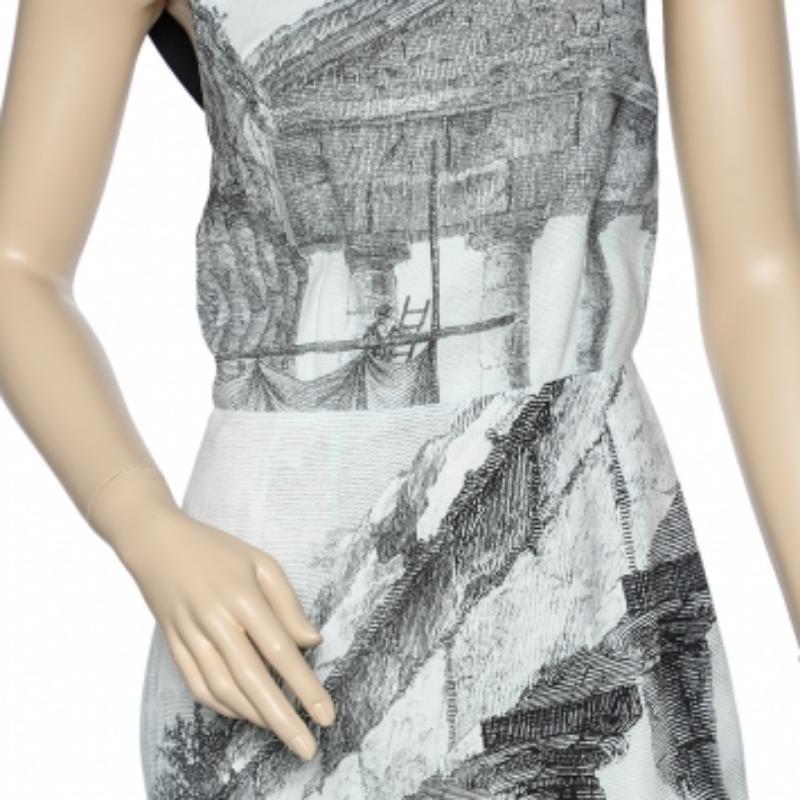 This dress from the House of Dolce & Gabbana exudes never-ending charm and beauty! It is tailored using monochrome crepe fabric, with a Temple print elevating their beauty. This dress features a midi-length silhouette, zip-type fastening, and a