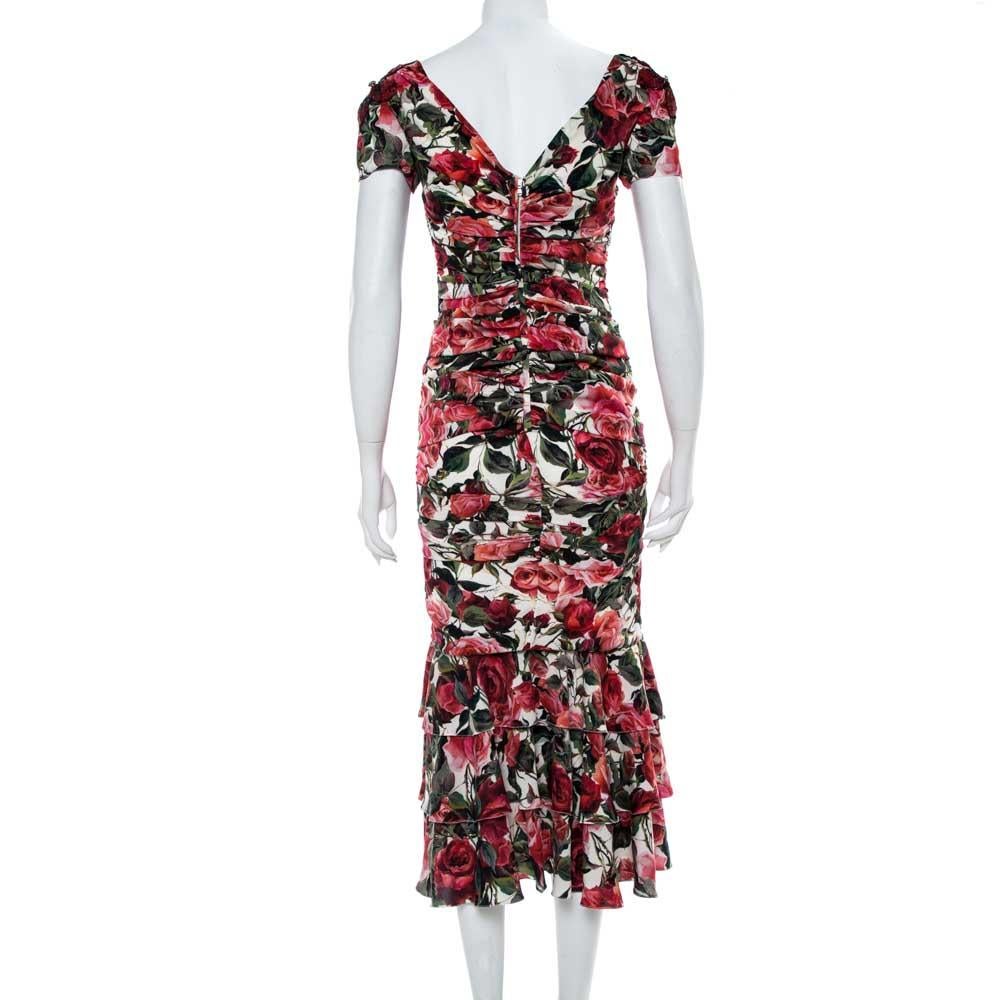 This stunning midi dress by Dolce & Gabbana flaunts the brand's romantic aesthetic and penchant for delivering beautiful prints. Crafted from silk crepe, it has multicolored hues, a floral print, ruched detailing, short sleeves, and a v-neckline.