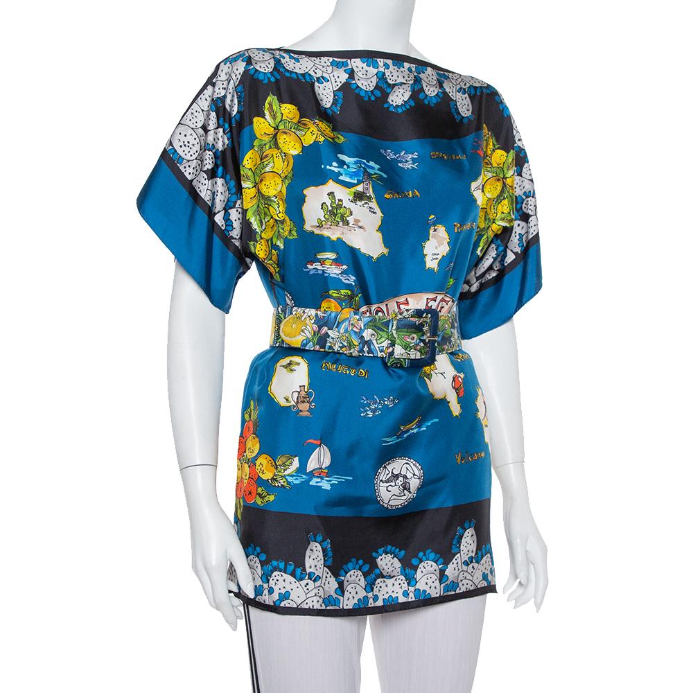 This uniquely designed top by Dolce & Gabbana has been made with silk in a beautiful blue color and an abstract print. It also has ‘Isole Eolie’ printed at the front and belted waist to cinch the oversized fit. Adorn it with contrasting tights for a