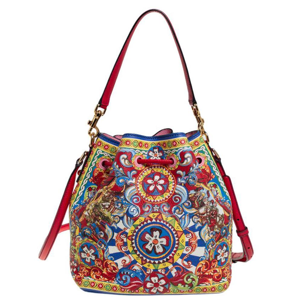 This wonderful Dolce & Gabbana creation is made from leather and enhanced with Majolica prints. The bag has a bucket shape with a drawstring closure that secures the interior. It is complete with a top handle and a shoulder strap. Dolce & Gabbana's