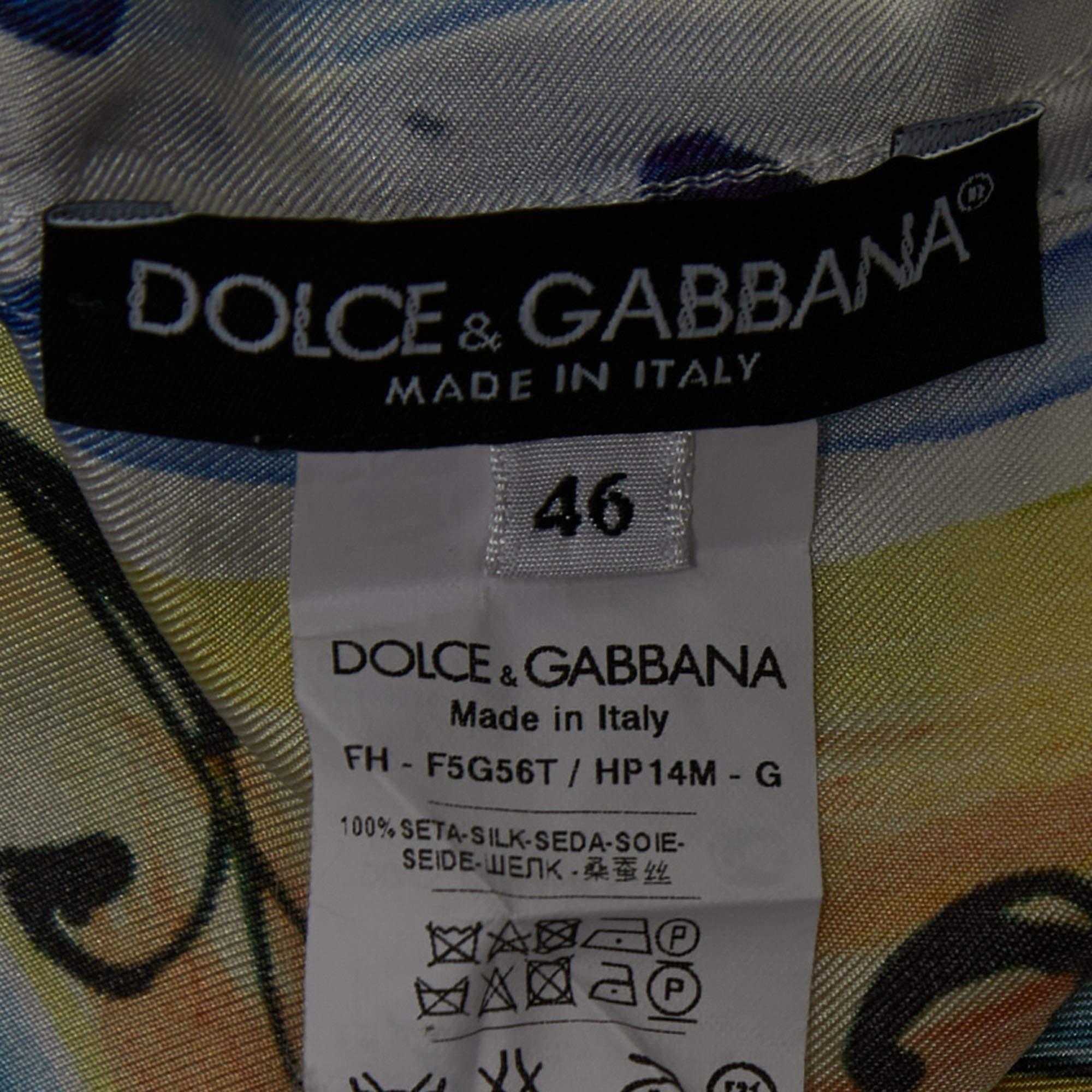 The Dolce & Gabbana shirt is a luxurious fashion piece. Made from fine silk, it features a vibrant and intricate Majolica tile-inspired print with bold, multicolored patterns. The shirt boasts a relaxed fit, button-down front, and a classic collar,