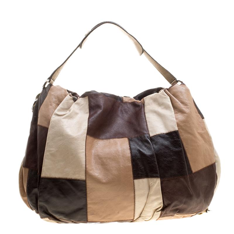 Featuring the ornate style of Dolce and Gabbana, this Miss Night and Day hobo is perfect for storing all that you need for the day and hence, is a must-have everyday essential. The pleated leather exterior is accented with multicoloured patchwork