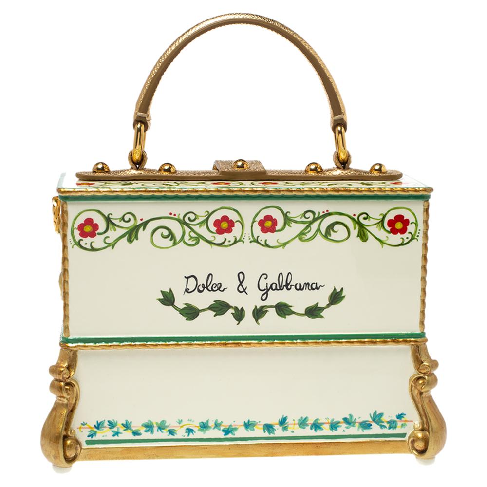 Statement bags from Dolce and Gabbana have always stood out and this multicolor creation validates that! It comes crafted from acrylic and leather and its box-like silhouette has been shaped to resemble an ornate piano. It is adorned with a flower