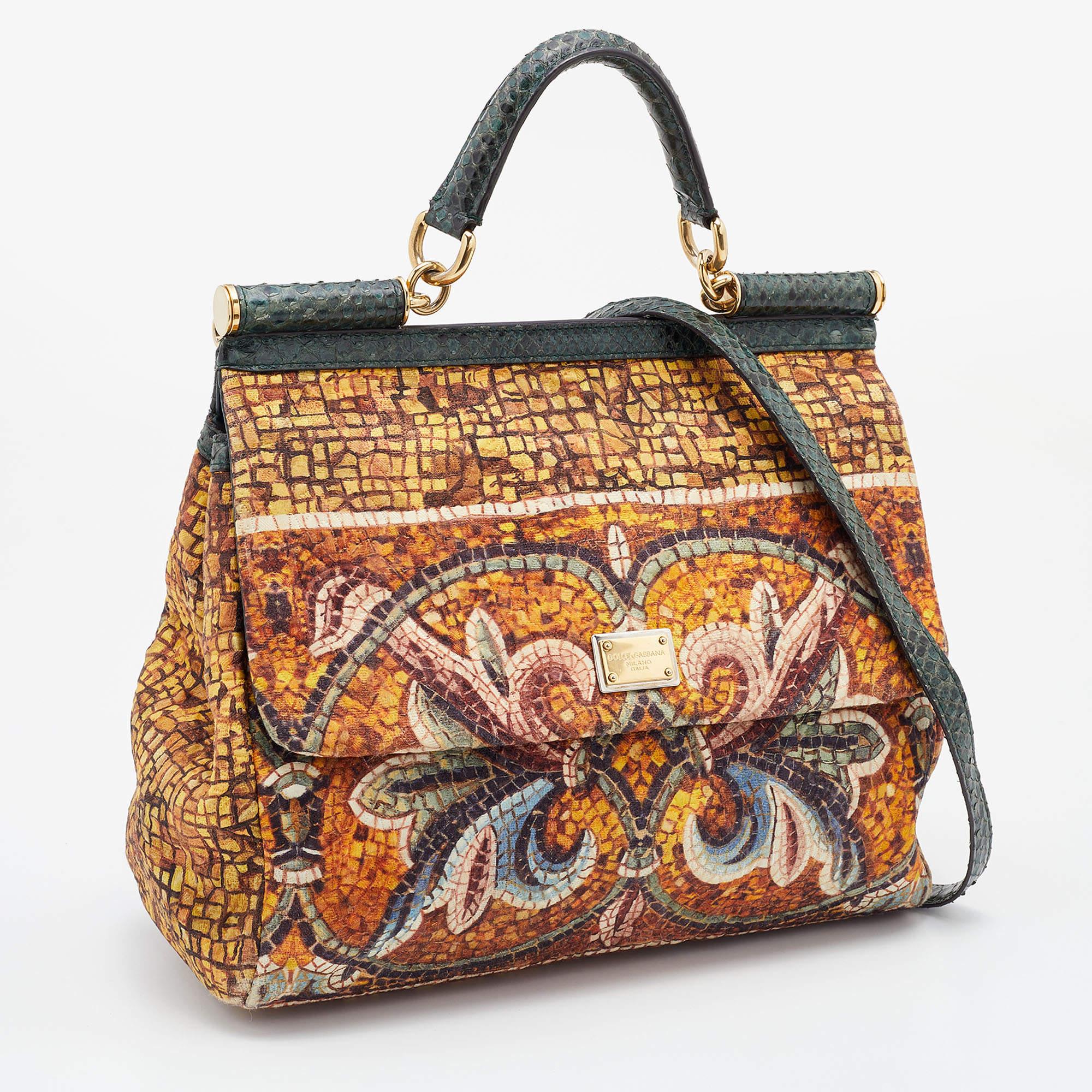 Presented for the 2009 Fall/Winter collection, Miss Sicily from Dolce & Gabbana represents the brand's regard for Italian essence and feminine style. This multicolor creation comes made from printed canvas and can be carried conveniently by a single