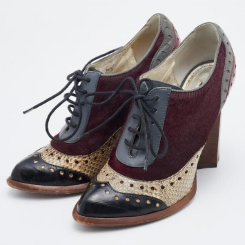 Nero Dolce & Gabbana, stivali in pelle di serpente e pelle di vitello con lacci, misura 38,5 in vendita