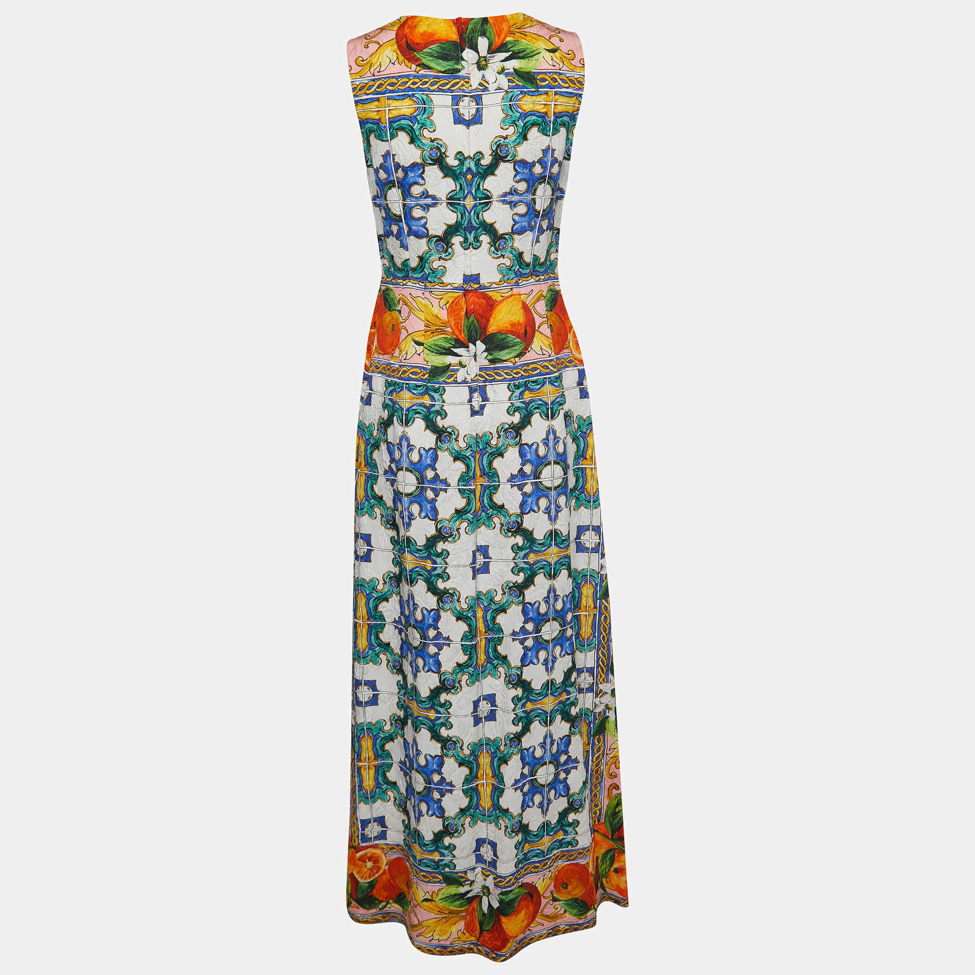 The Dolce & Gabbana dress is a stunning blend of vibrant colors and intricate patterns inspired by Sicilian culture. This sleeveless midi dress features a unique print resembling traditional Sicilian tiles, creating a visually striking and artistic