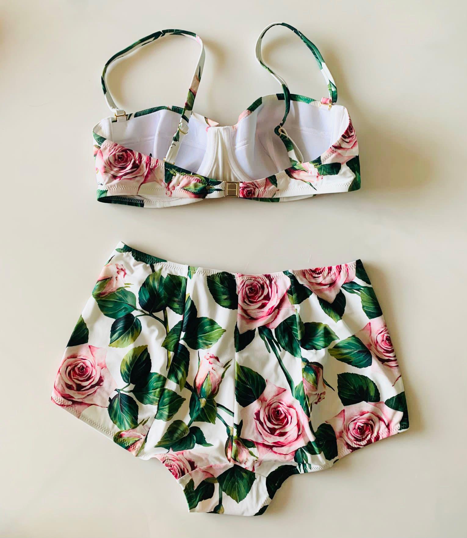 Dolce & Gabbana romantic built-in balcony bra bikini top offers a sophisticated look thanks to the TROPICAL ROSE print and is made of the precious “sensitive fabric”. The shaped cups guarantee structure and support. 
The bikini bottom with high