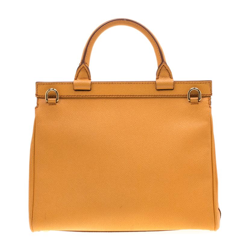 The rich mustard colour brings this ‘Monica’ tote by Dolce & Gabbana alive. It features gold-tone hardware and a spacious interior lined in leopard-printed fabric. It comes with a convenient top handle and a detachable crossbody strap. It also has a