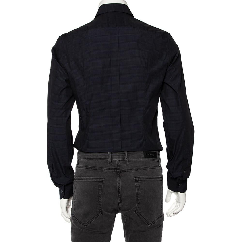 Shirts are an indispensable part of a man's wardrobe, so Dolce & Gabbana brings you a creation that is both versatile and stylish. It has been tailored from cotton in a navy blue shade. The shirt is detailed with intricate patterns and long