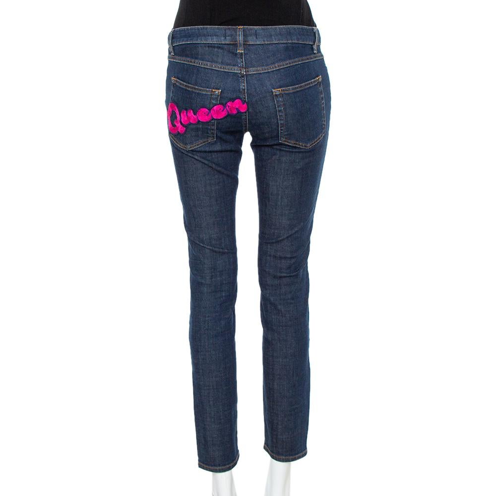 Looking for a pair of designer skinny jeans? Dolce & Gabbana has the one just for you! Made from a cotton blend, the navy blue denim jeans are sewn to offer a skinny fit. The simple pair is highlighted by a pink 'Queen' appliqué on the back.

