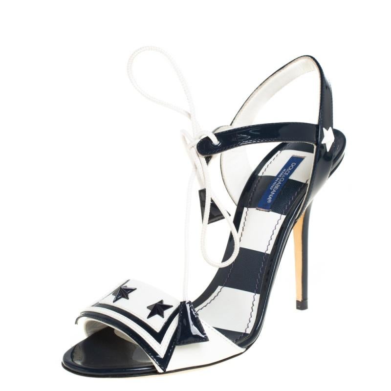 Leave your audience spellbound with this pair of Dolce & Gabbana sandals! These beautiful sandals have been styled with perfection just so a diva like you can flaunt them. In navy blue and white, the pair has been crafted from patent leather and